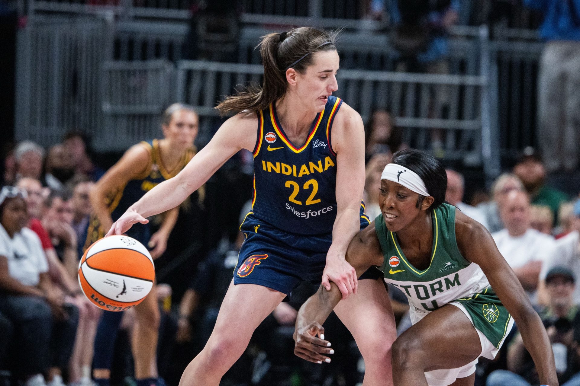 Indiana Fever guard Caitlin Clark (22) dribbles against Seattle Storm guard Flau'jae Johnson (4) in the first half at Gainbridge Fieldhouse.