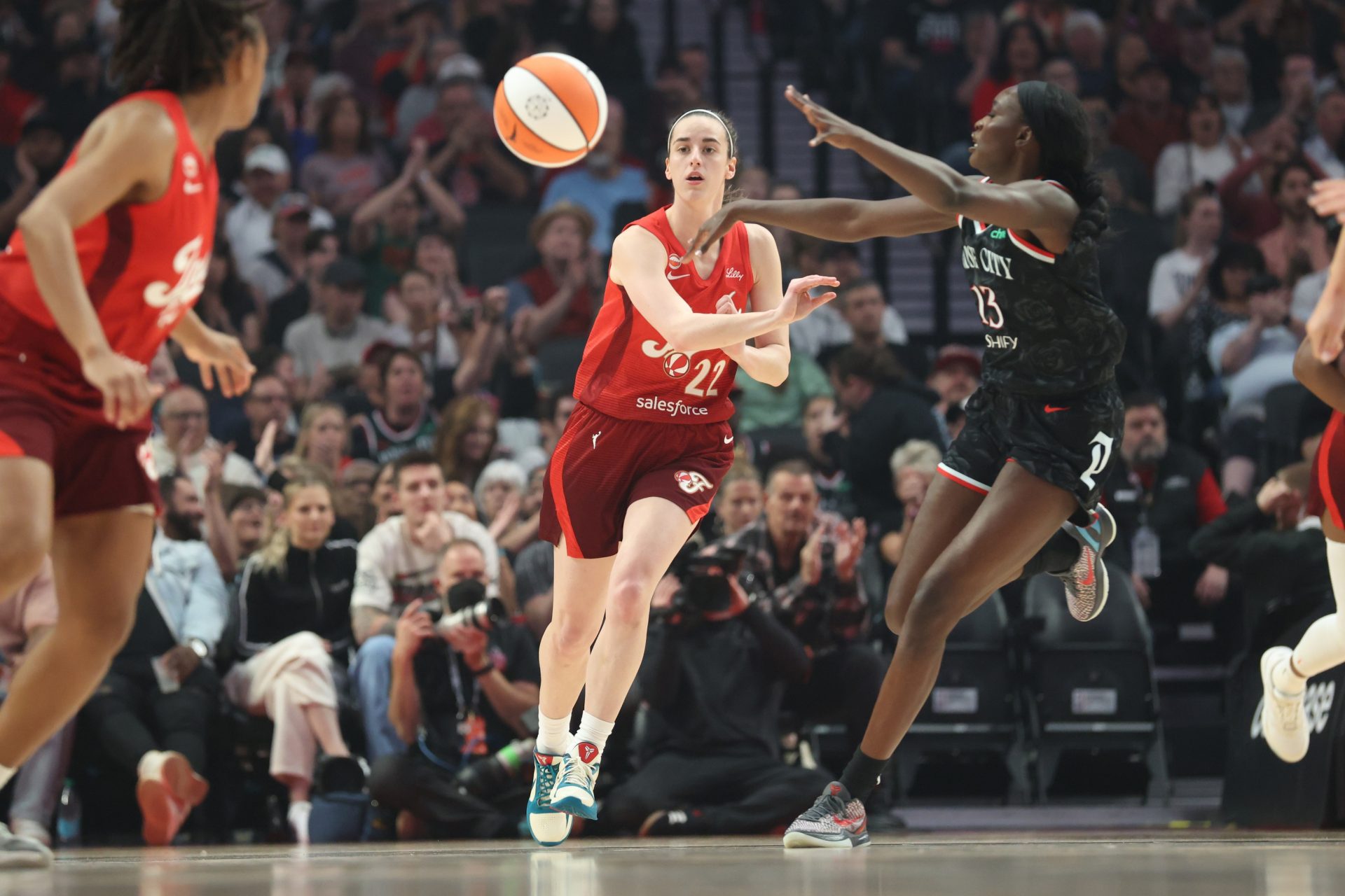 Indiana Fever guard Caitlin Clark (22) passes the ball down court against Portland Fire forward Nyadiew Puoch (13) during the first half at Moda Center - Source: Imagn Images