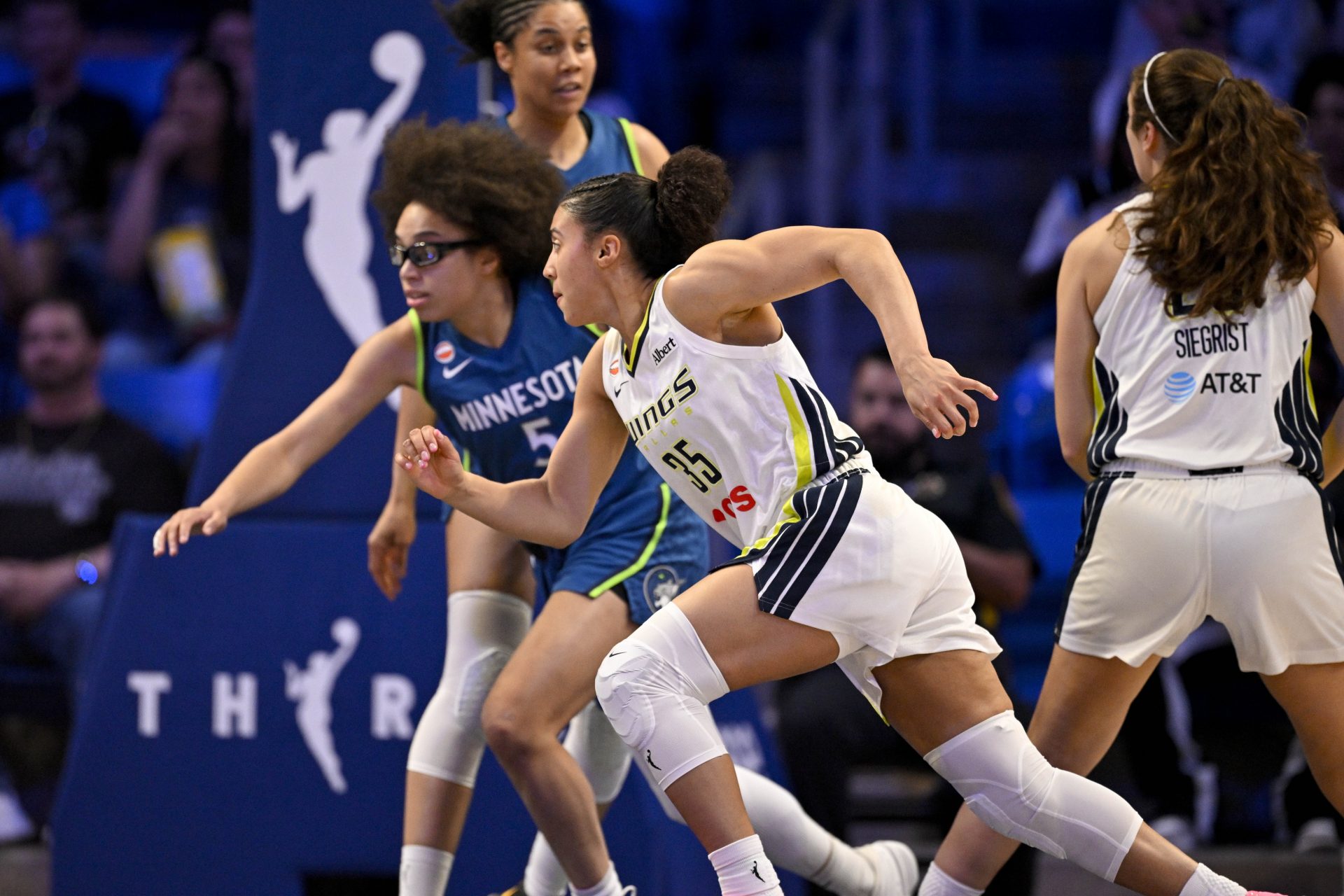 Minnesota Lynx guard Olivia Miles (5) and Dallas Wings guard Azzi Fudd (35) chase the ball during the first half at College Park Center.