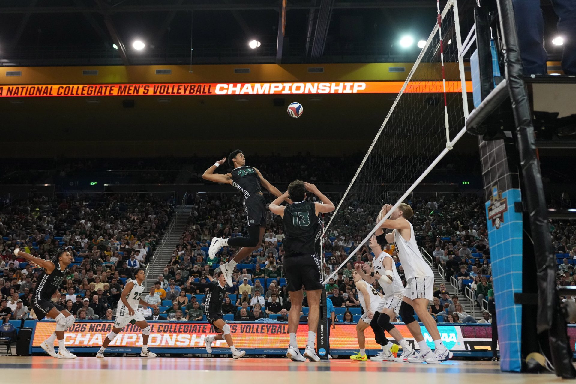 Hawaii Rainbow Warriors middle blocker Trevell Jordan (20) hits the ball against Long Beach State during a NCAA Volleyball championship semifinal at Pauley Pavilion.