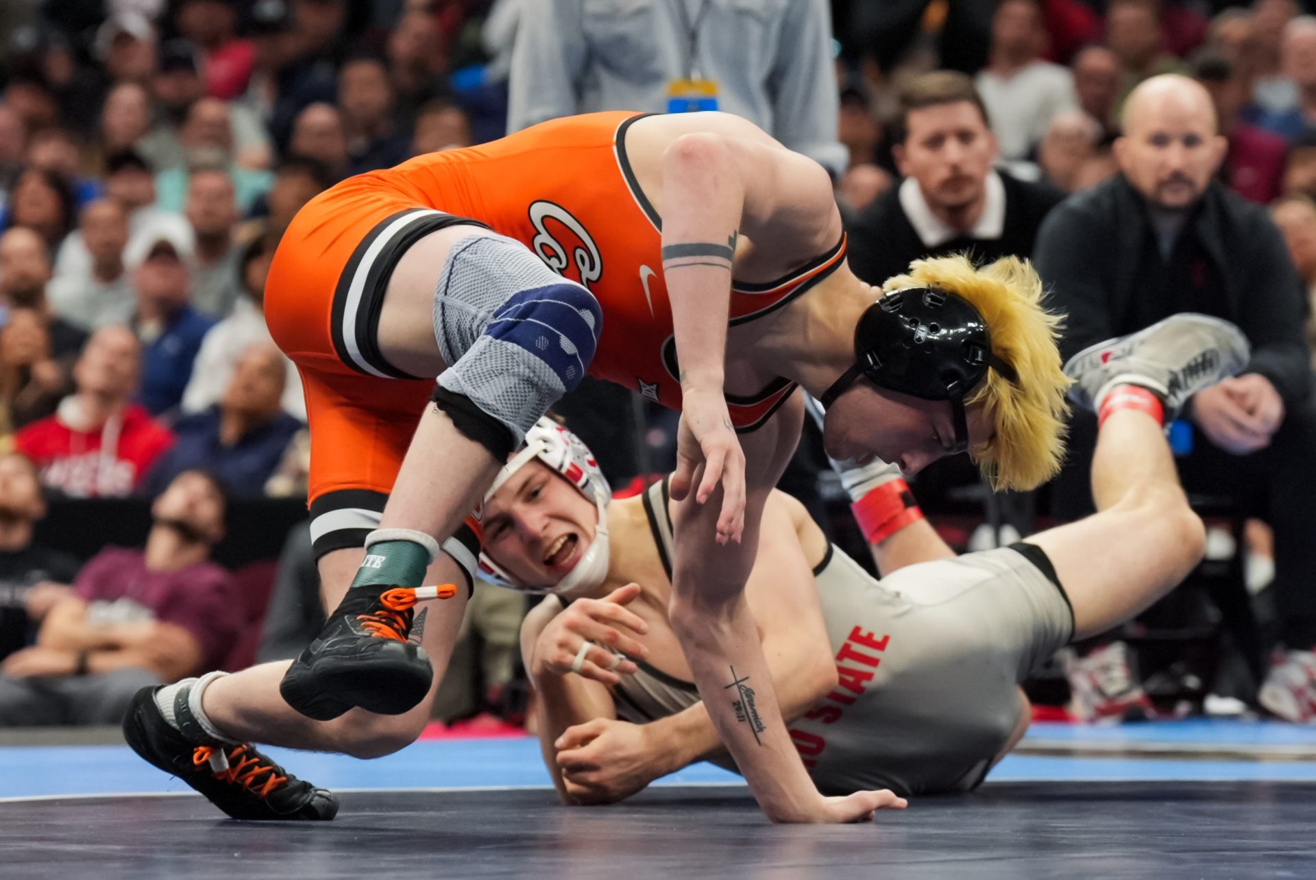 Oklahoma State Cowboys Jax Forrest competes against Ohio State Buckeyes Ben Davino during the NCAA DI Wrestling Championship at Rocket Arena.