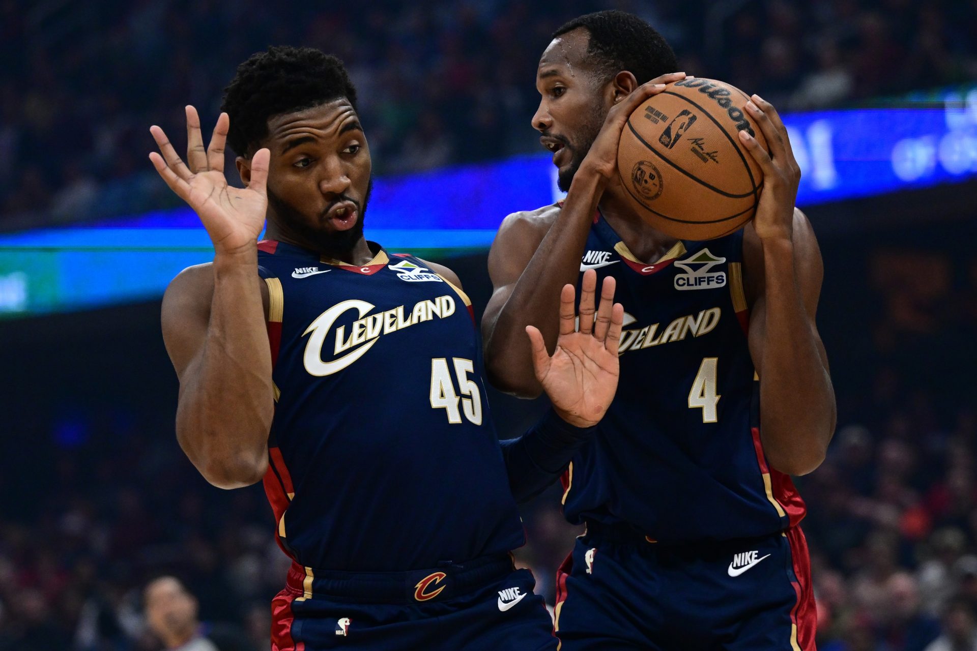 Cleveland Cavaliers guard Donovan Mitchell (45) gets out of the way as center Evan Mobley (4) grabs a rebound during the first half at Rocket Arena - Source: Imagn Images