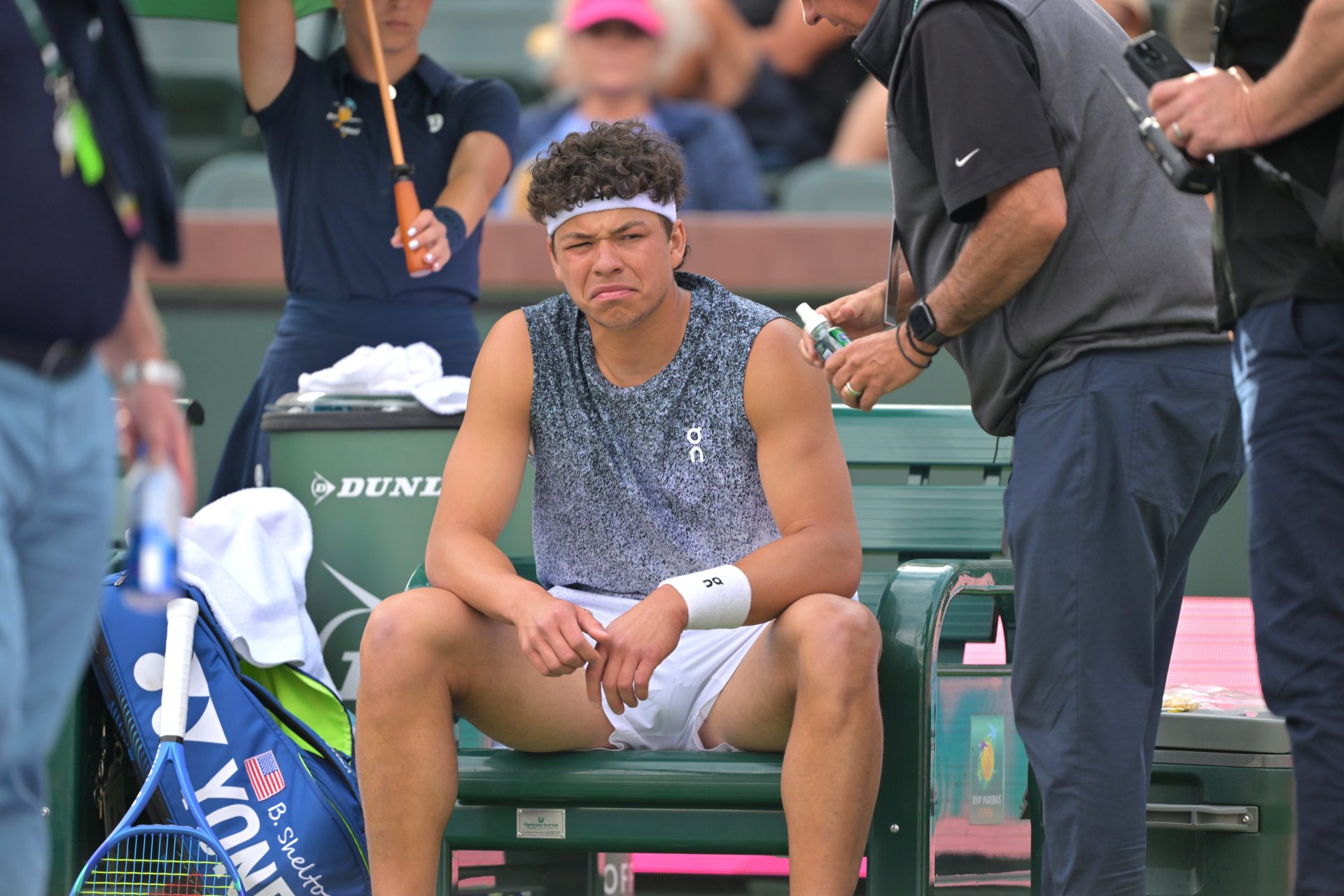 Ben Shelton (USA) reacts after getting a shot of throat spray from the medical team during his second round match against Reilly Opelka (USA) in the BNP Paribas Open at the Indian Wells Tennis Garden.