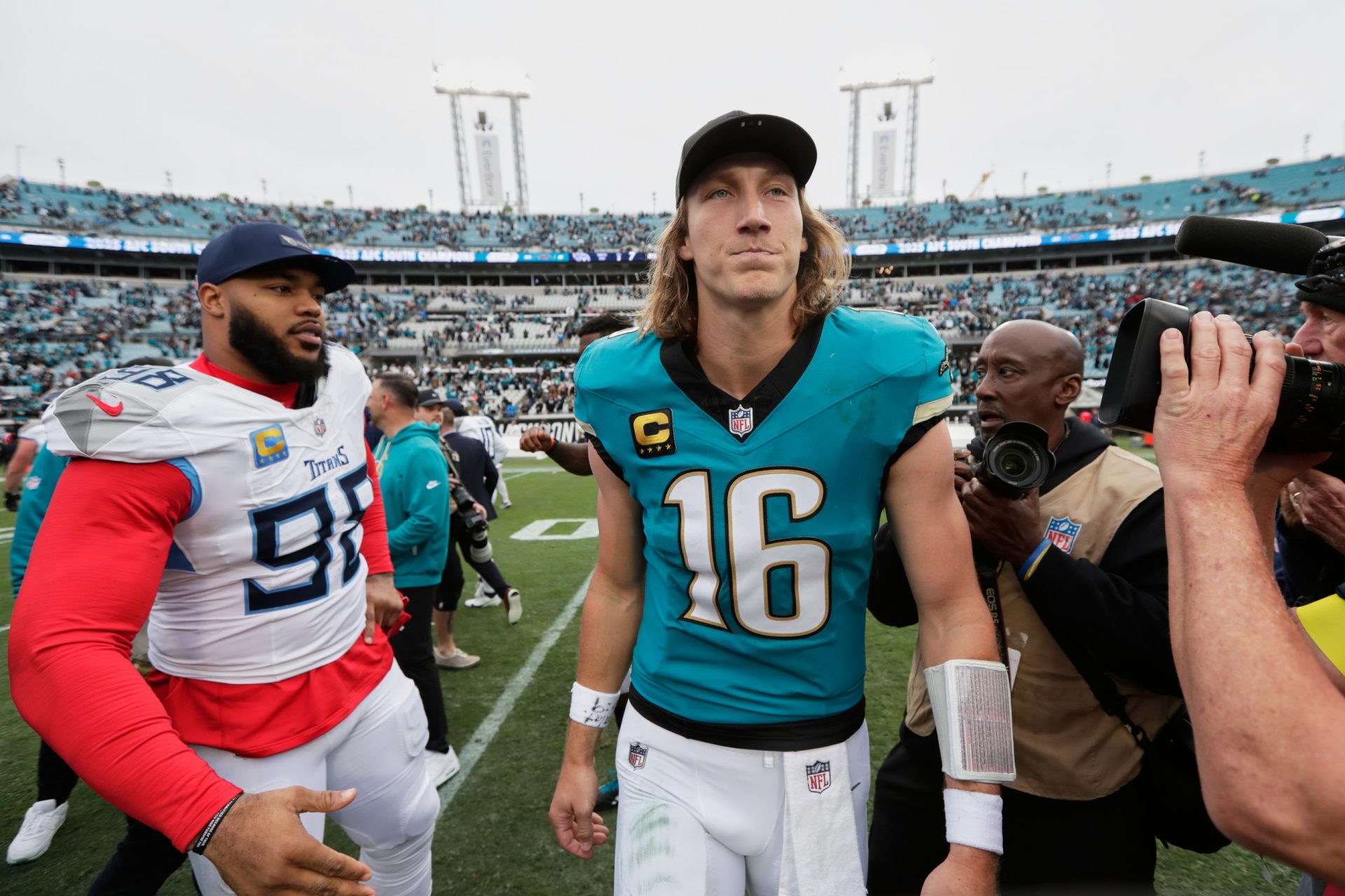 Jacksonville Jaguars quarterback Trevor Lawrence (16) and Tennessee Titans defensive tackle Jeffery Simmons (98) shake hands after the game at EverBank Stadium.