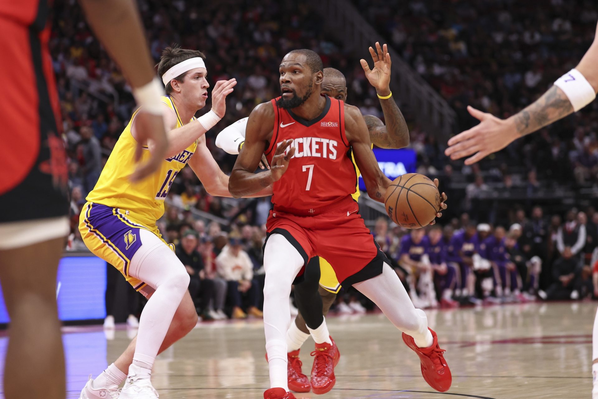 Houston Rockets forward Kevin Durant (7) dribbles the ball as Los Angeles Lakers guard Austin Reaves (15) defends during the first quarter at Toyota Center.