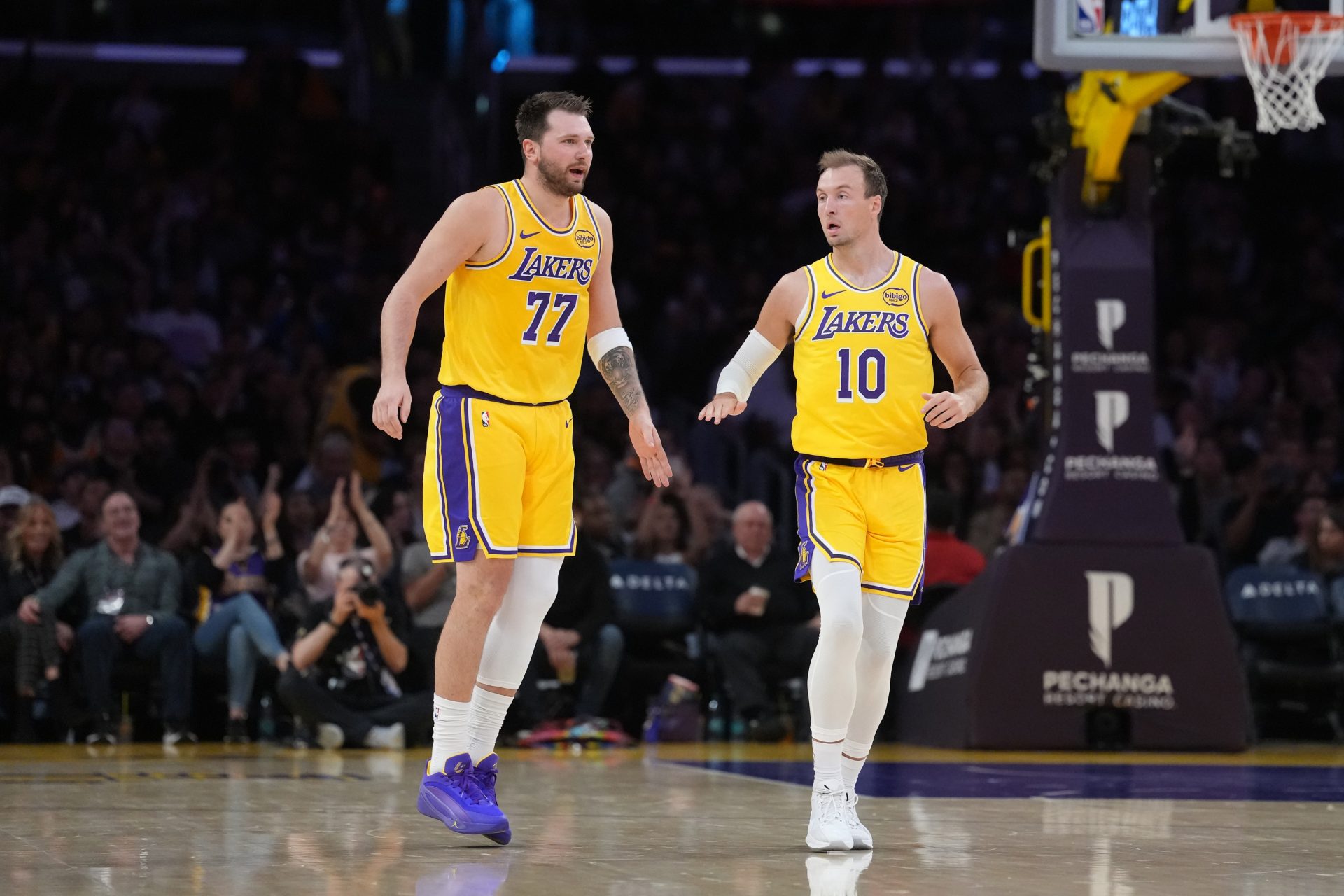 Los Angeles Lakers guard Luka Doncic (77) and guard Luke Kennard (10) react against the Indiana Pacers in the first half at Crypto.com Arena.