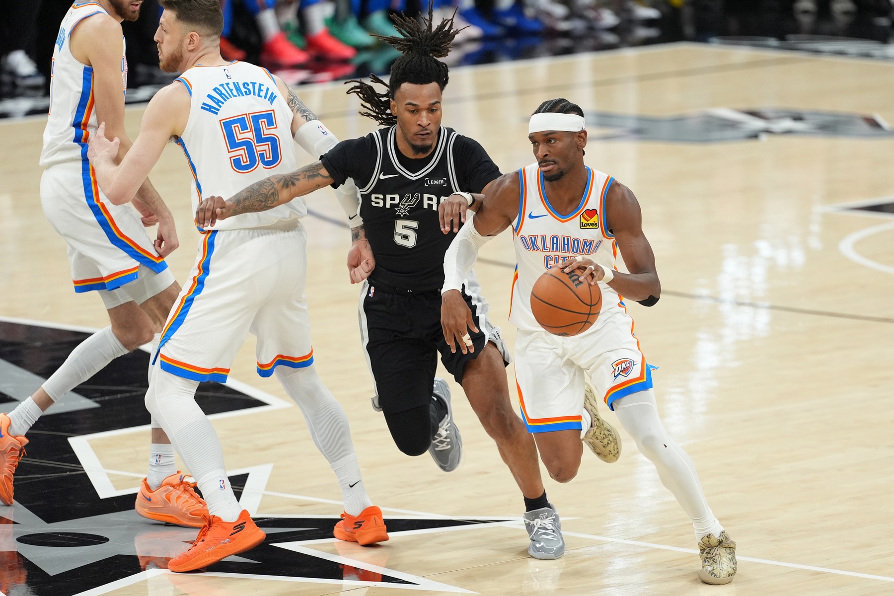 Oklahoma City Thunder guard Shai Gilgeous-Alexander (2) dribbles the ball past San Antonio Spurs guard Stephon Castle (5) in the first half during game six of the western conference finals for the 2026 NBA playoffs at Frost Bank Center - Source: Imagn Images