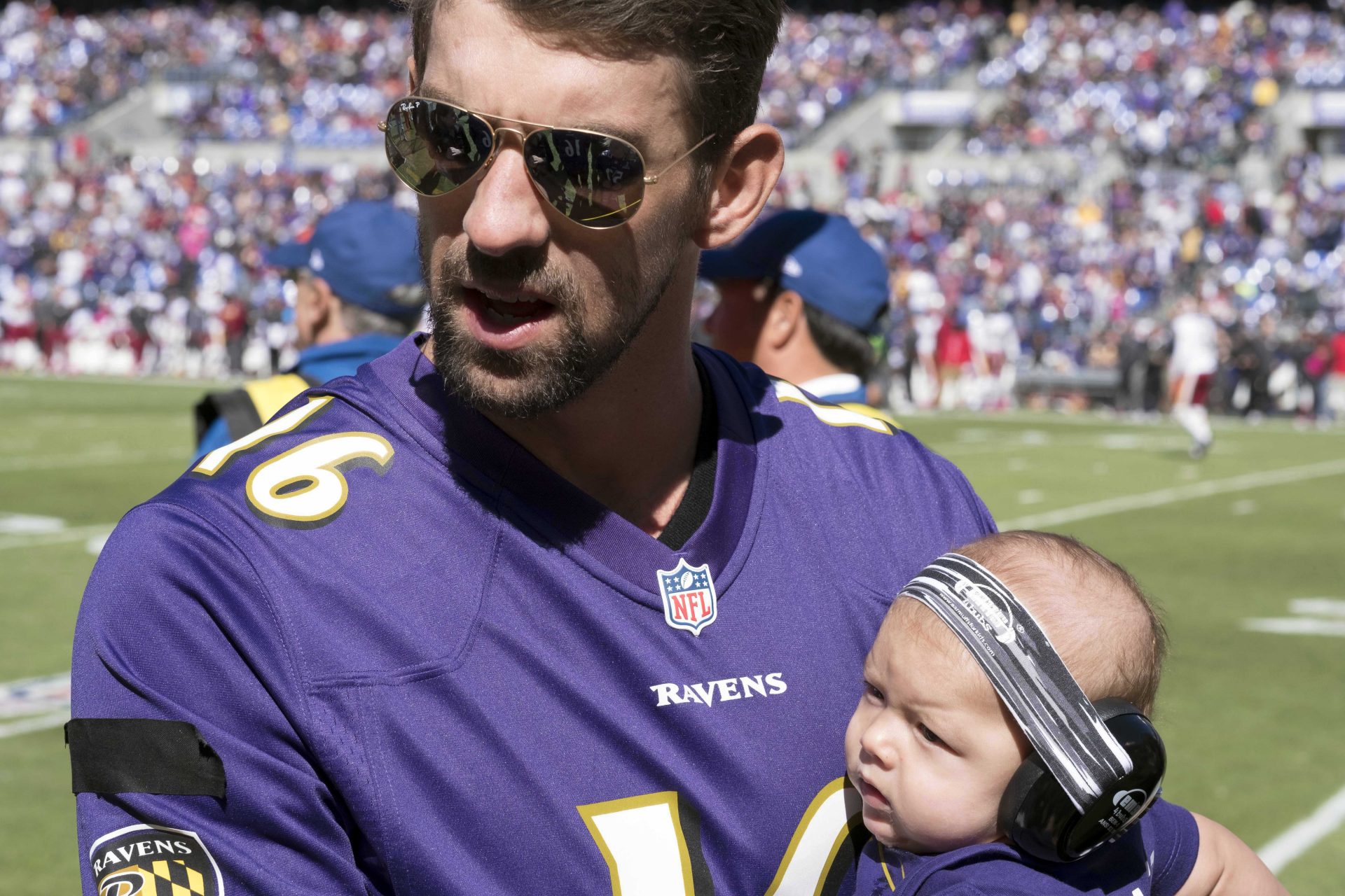 United States Olympian Michael Phelps and his son Boomer attend the Washington Redskins game against the Baltimore Ravens at M&T Bank Stadium.