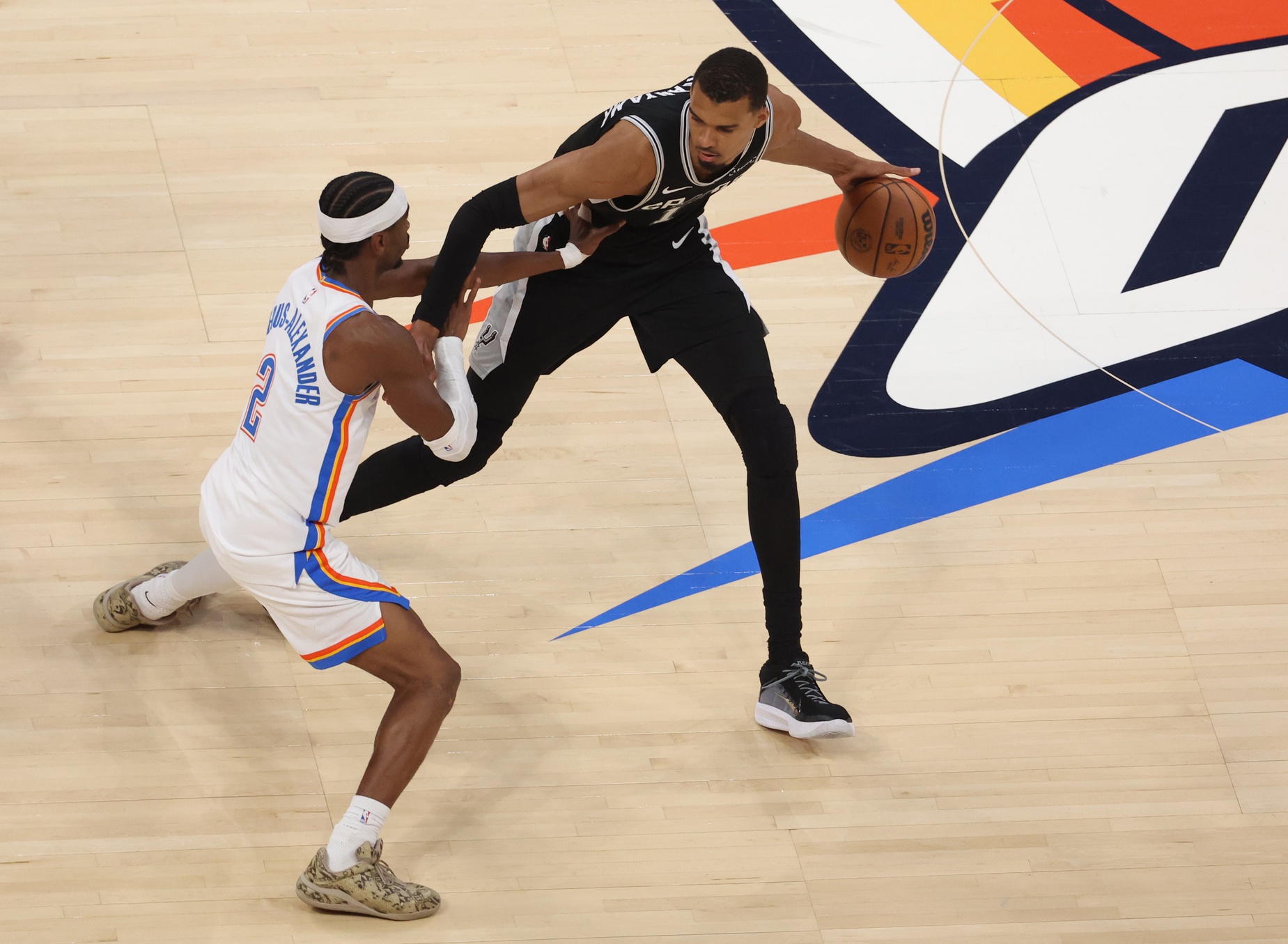 San Antonio Spurs forward Victor Wembanyama (1) dribbles against Oklahoma City Thunder guard Shai Gilgeous-Alexander (2) during the second quarter in game five of the western conference finals for the 2026 NBA playoffs at Paycom Center - Source: Imagn Images