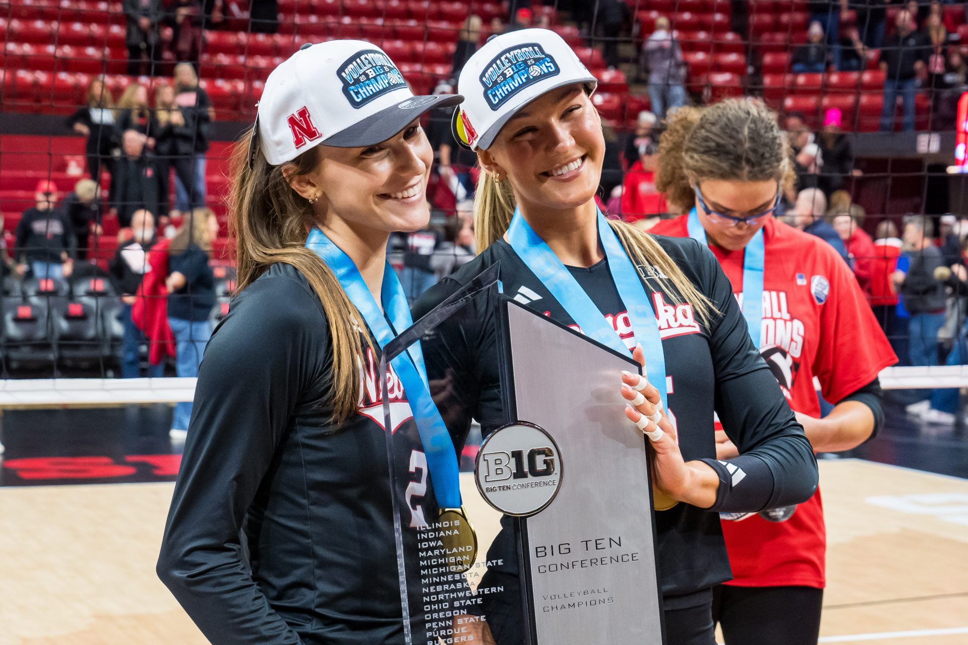Nebraska Cornhuskers setter Bergen Reilly (2) and middle blocker Andi Jackson (15) pose with the 2025 Big Ten Volleyball Champions trophy after the match against the Penn State Nittany Lions at Bob Devaney Sports Center.