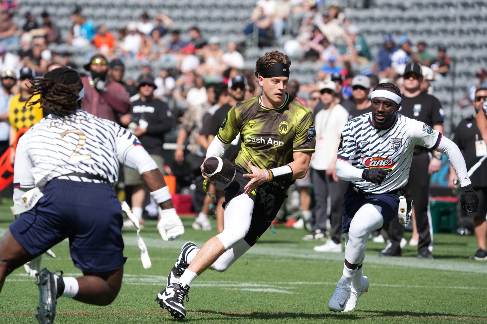 Wildcats FFC quarterback Joe Burrow carries the ball against Ashton Jeanty of Founders FFC during the Fanatics Flag Football Classic at BMO stadium. Source: Imagn