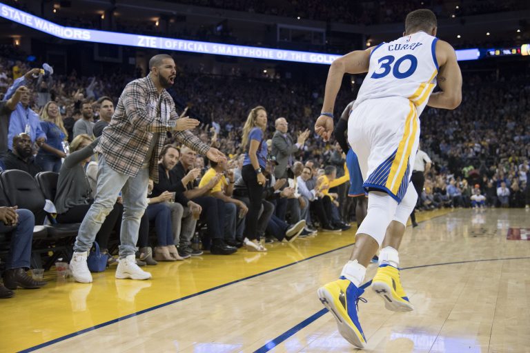 Drake celebrates after Golden State Warriors guard Stephen Curry (30) made a three-point basket against the Oklahoma City Thunder.
Source: Kyle Terada-USA TODAY Sports