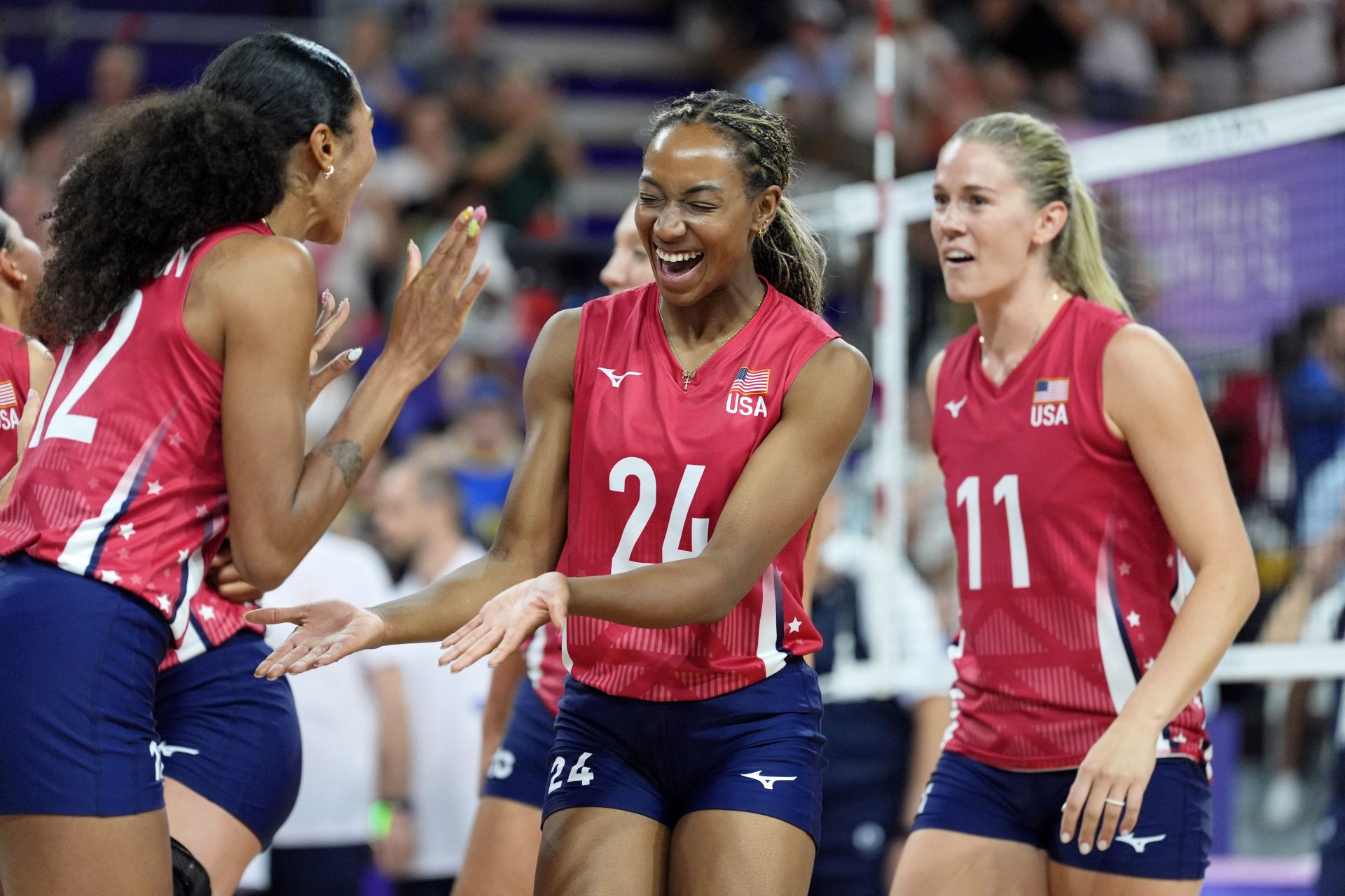 United States opposite Jordan Thompson (12) celebrates with middle blocker Chiaka Ogbogu (24) after their win against Poland during the Paris 2024 Olympic Summer Games at South Paris Arena 1.