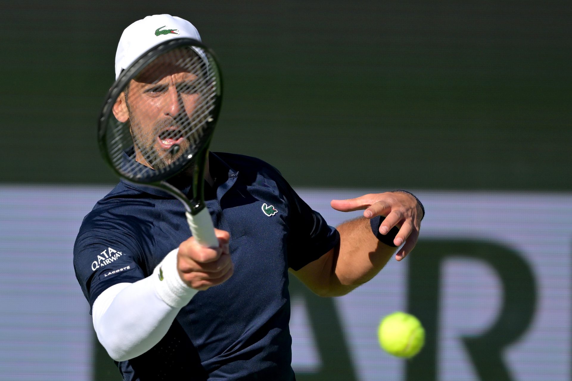 Novak Djokovic (SRB) hits a shot during his second round match against Kamil Majchrzak (POL) in the BNP Paribas Open at the Indian Wells Tennis Garden.