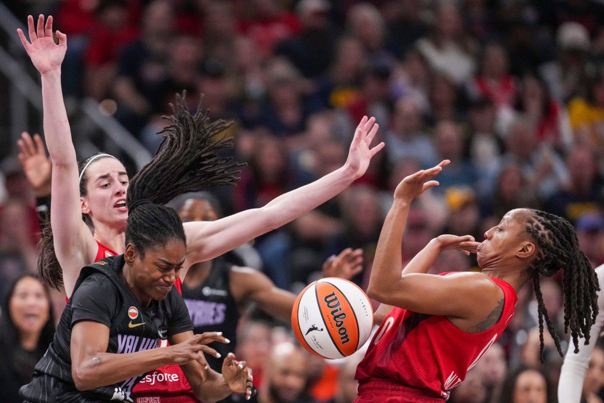 Indiana Fever guard Caitlin Clark (22), Golden State Valkyries guard Tiffany Hayes (15) and Indiana Fever guard Kelsey Mitchell (0) react to a loose ball Friday, May 22, 2026, during a game at Gainbridge Fieldhouse in Indianapolis. The Indiana Fever defeated the Golden State Valkyries, 90-82.