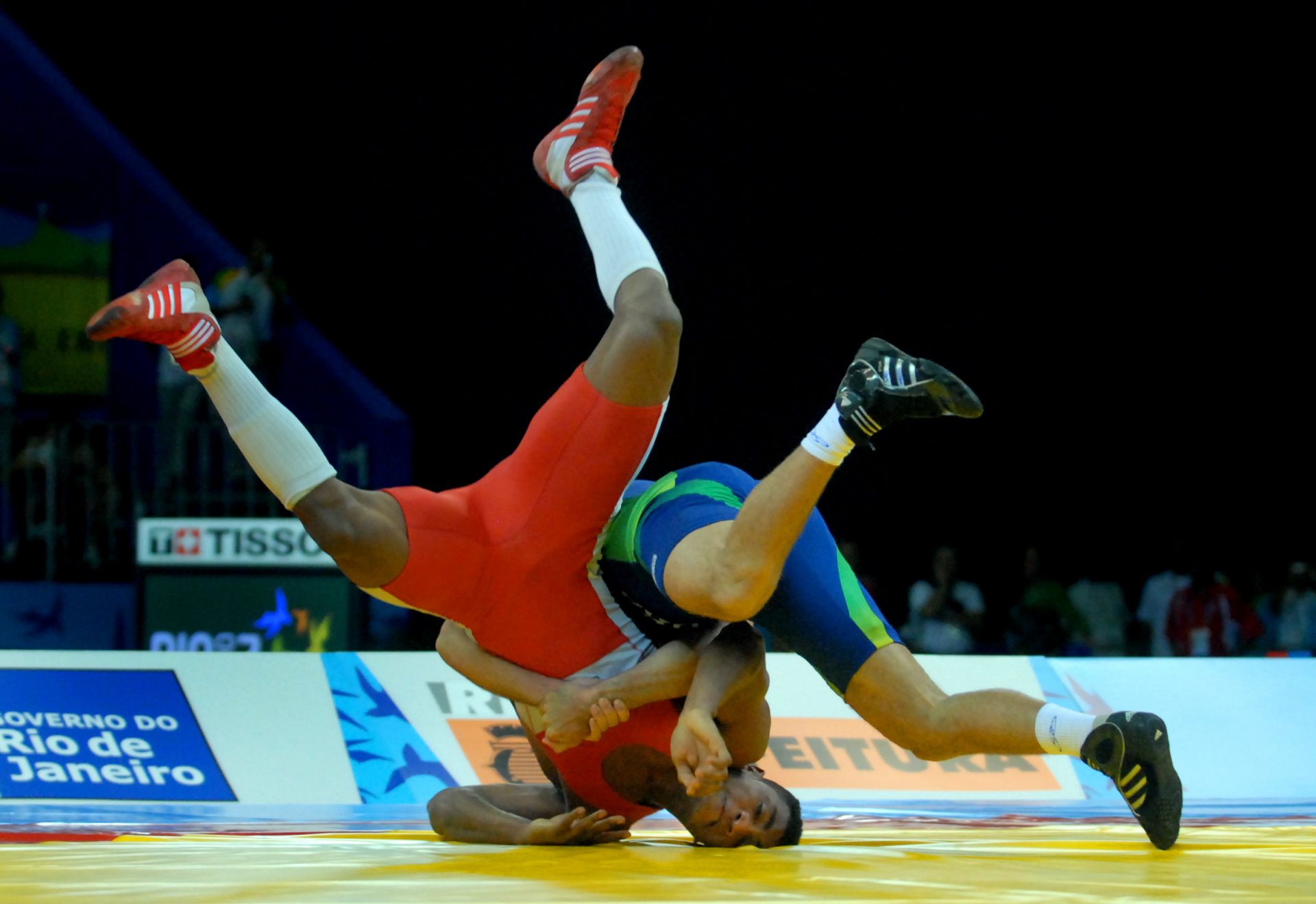 Marcelo Mina (ECU), red, against Felipe Macedo (BRA) in the 74kg mens greco roman wrestling finals in the Pan American Games at the Rio Centro Pavilion in Rio de Janeiro.
