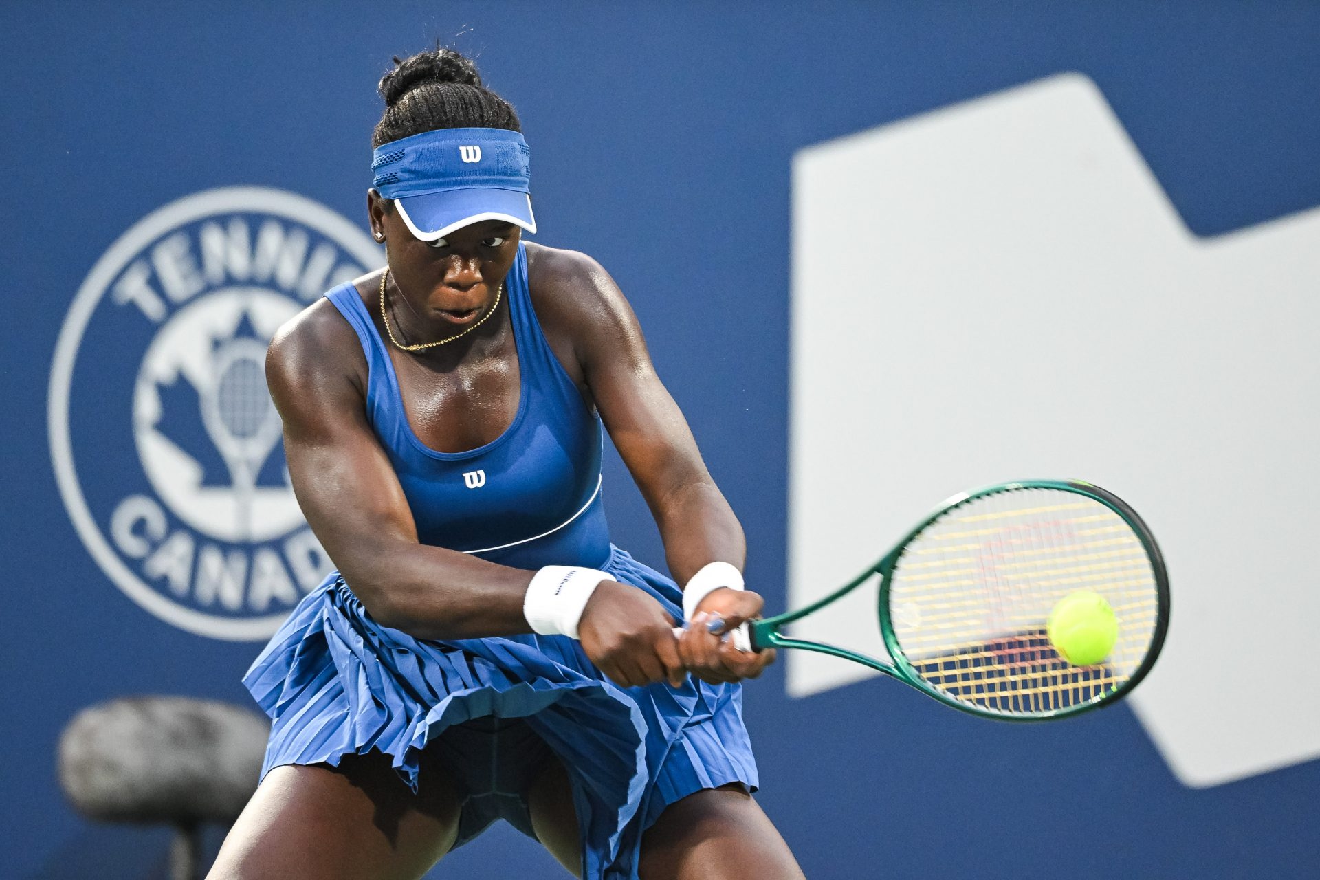 Victoria Mboko (CAN) returns the ball to Coco Gauff (USA) in fourth round play at IGA Stadium.