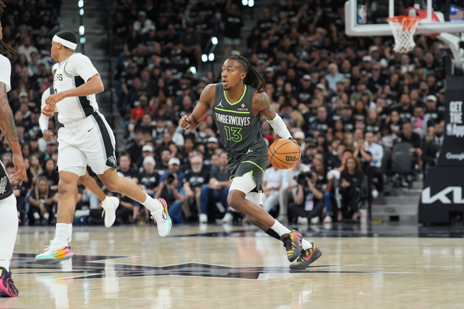 Minnesota Timberwolves guard Ayo Dosunmu (13) dribbles in the first half against the San Antonio Spurs during game two of the second round of the 2026 NBA Playoffs at Frost Bank Center.
