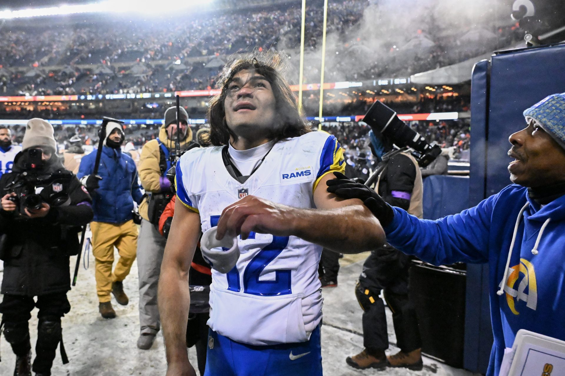 Los Angeles Rams wide receiver Puka Nacua (12) gives his wristband to a fan as he leaves the field after an NFC Divisional Round game against the Chicago Bears at Soldier Field.