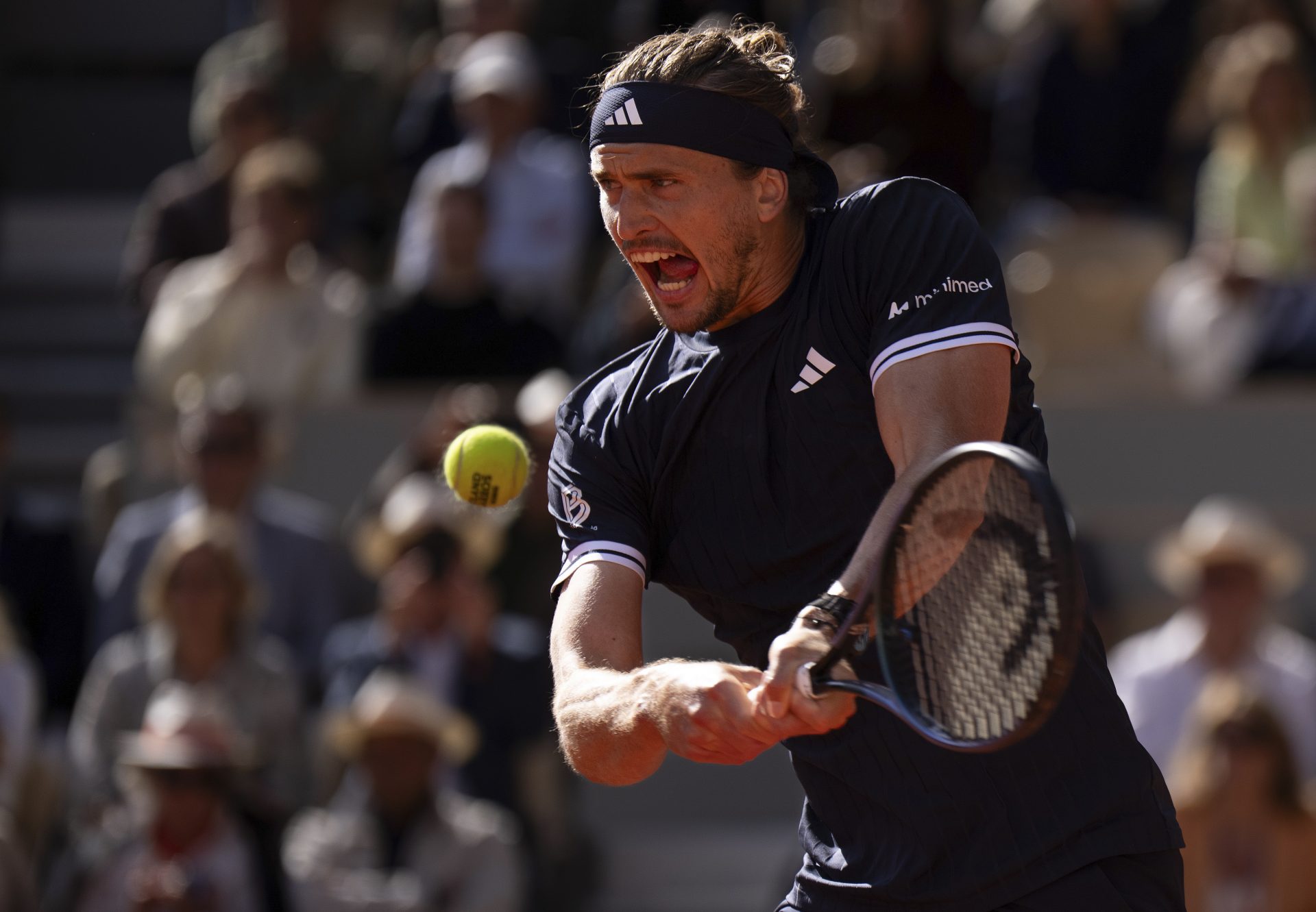 Alexander Zverev of Germany returns a shot during his match against Jakub Mensik of Czechia on day 12 at Stade Roland Garros.