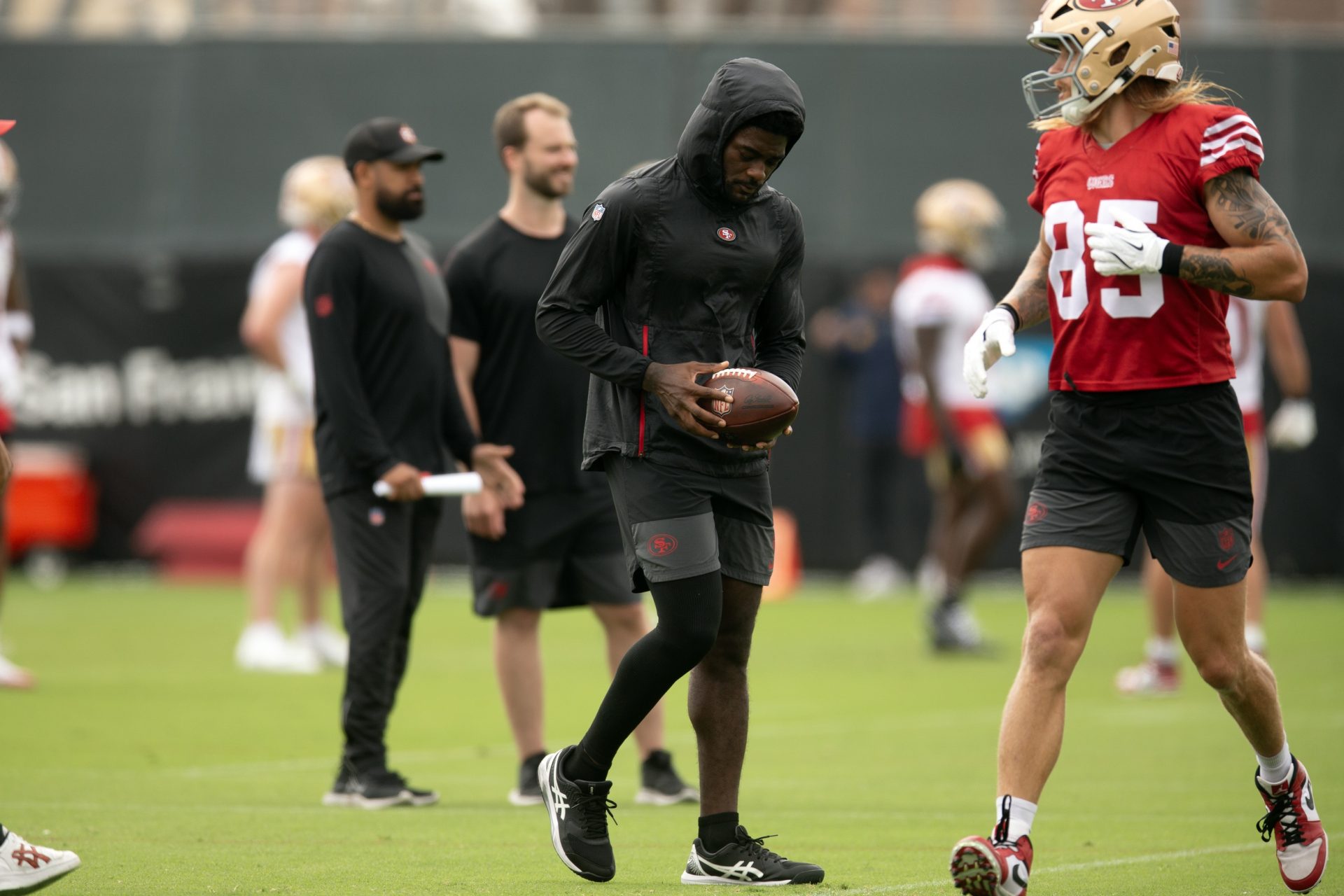 Still recovering from knee surgery, San Francisco 49ers wide receiver Brandon Aiyuk (left)  hangs out with teammate George Kittle (85) during the second day of training camp.