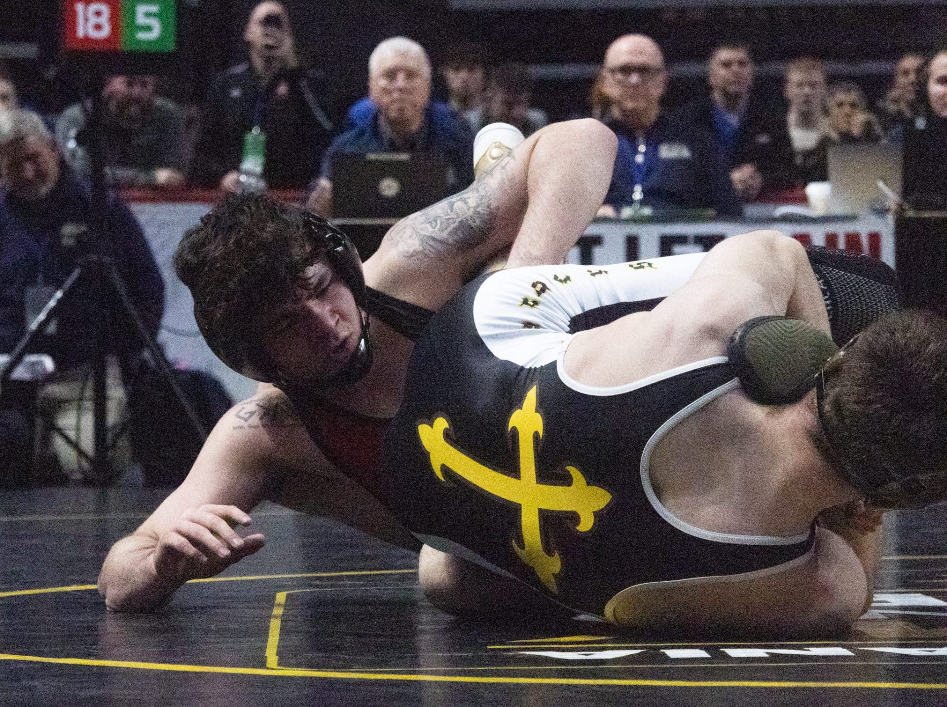 Bishop McCort’s Bo Bassett looks to score against Bishop McDevitt’s Greyson Music at 145 pounds in PIAA AA Day 2 action on Friday, Mar. 6 2026 at the Giant Center. Bassett won 21-6 by tech fall to advance to his career’s third PIAA finals matchup.