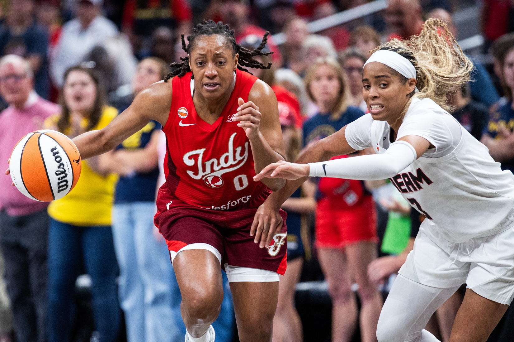Indiana Fever guard Kelsey Mitchell (0) dribbles against Atlanta Dream guard Jordin Canada (3) in the second half at Gainbridge Fieldhouse.