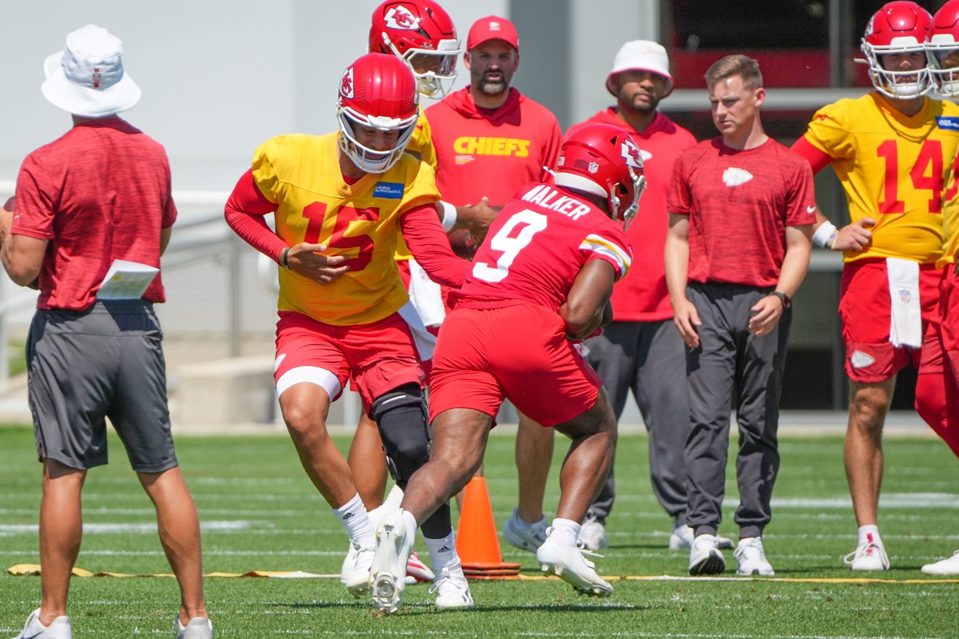 Kansas City Chiefs quarterback Patrick Mahomes (15) hands off to Kansas City Chiefs running back Kenneth Walker (9) during the Kansas City Chiefs mandatory mini-camp at the Chiefs practice facility.