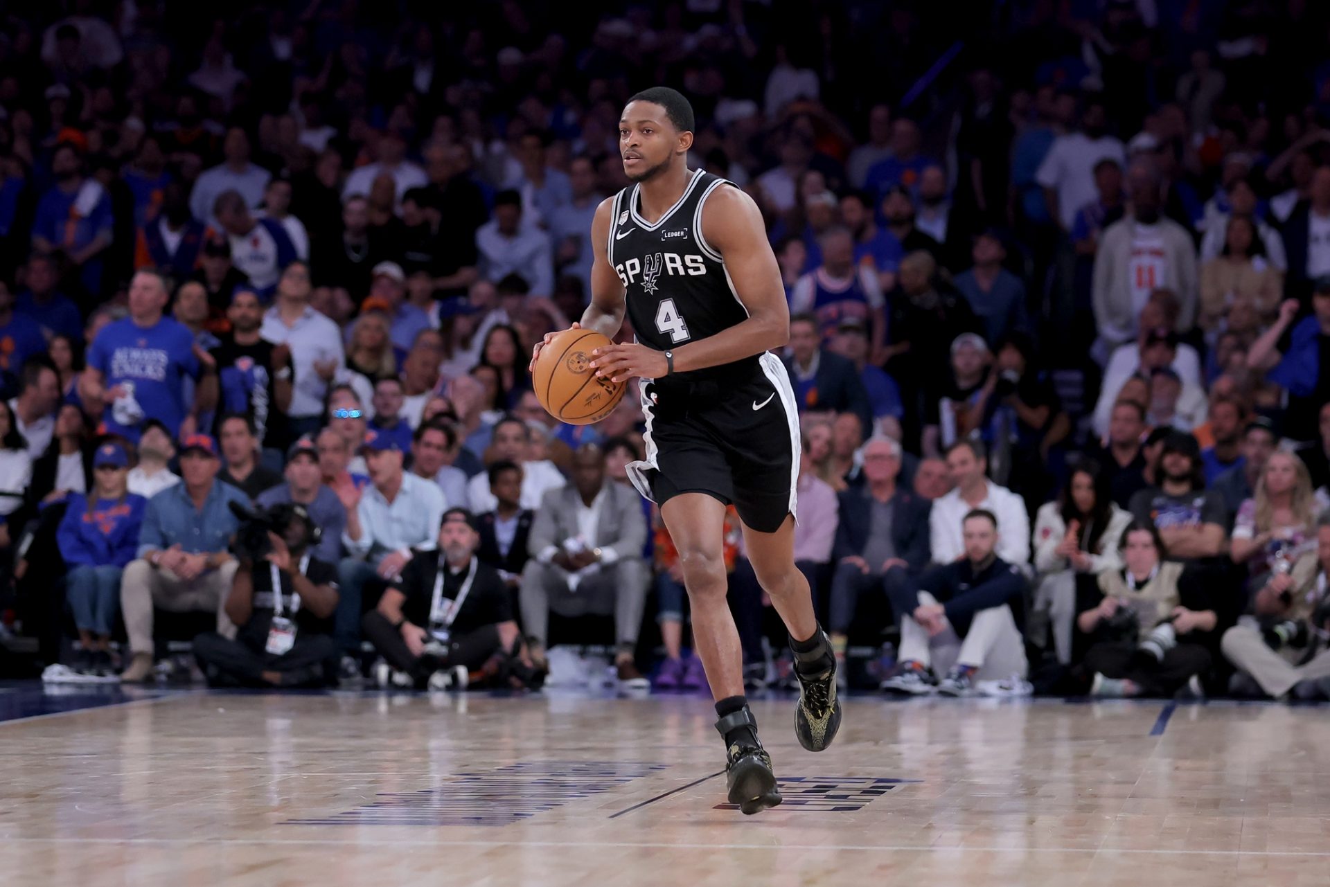 San Antonio Spurs guard De'aaron Fox (4) brings the ball up court against the New York Knicks during the fourth quarter of game four of the 2026 NBA Finals at Madison Square Garden - Source: Imagn Images