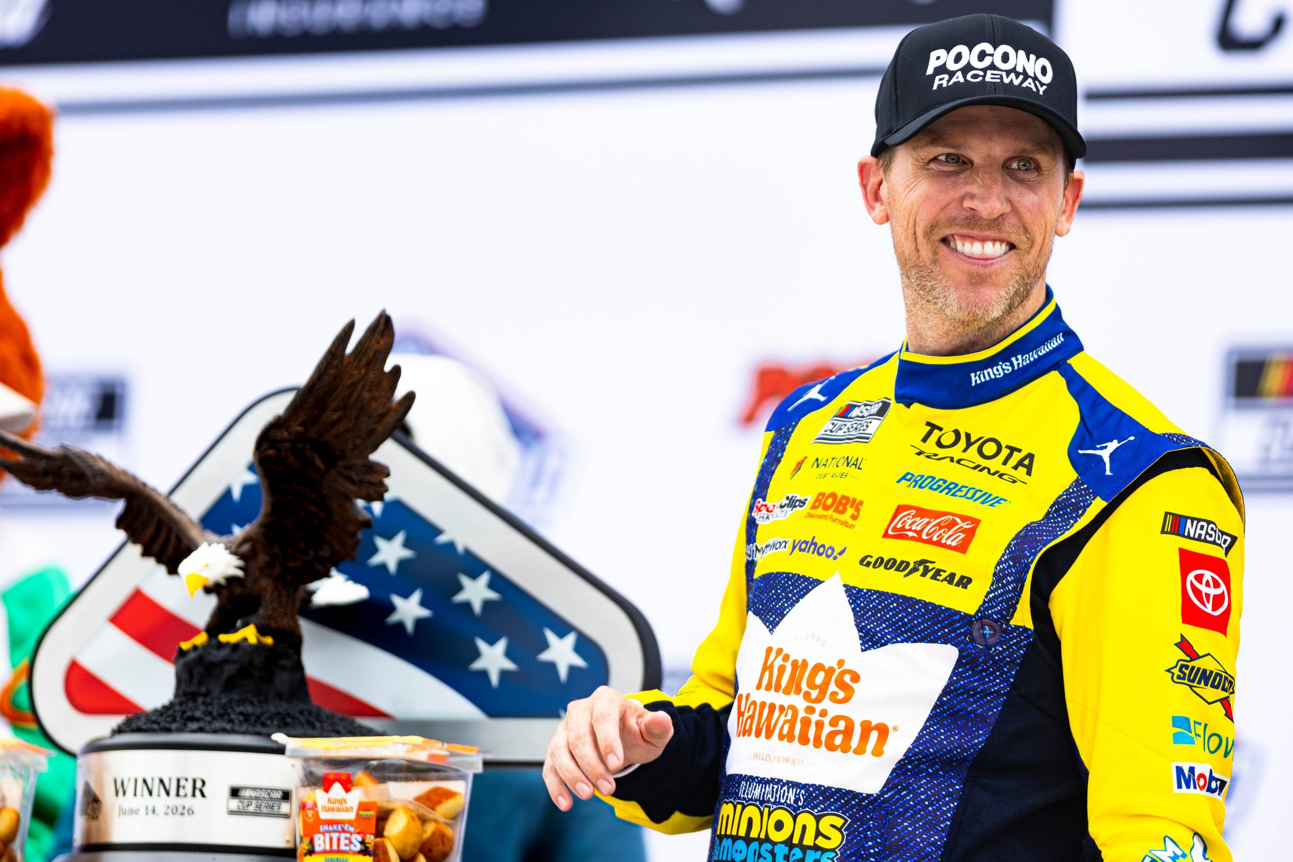 NASCAR Cup Series driver Denny Hamlin poses with the trophy after winning the Great American Getaway 400 on June 14, 2026.