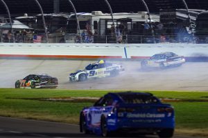 Carson Hocevar (77) and Hendrick Motorsports driver Chase Elliott (9) and Team Penske driver Ryan Blaney (12) crash at the end of the Cracker Barrel 400 at Nashville Superspeedway.