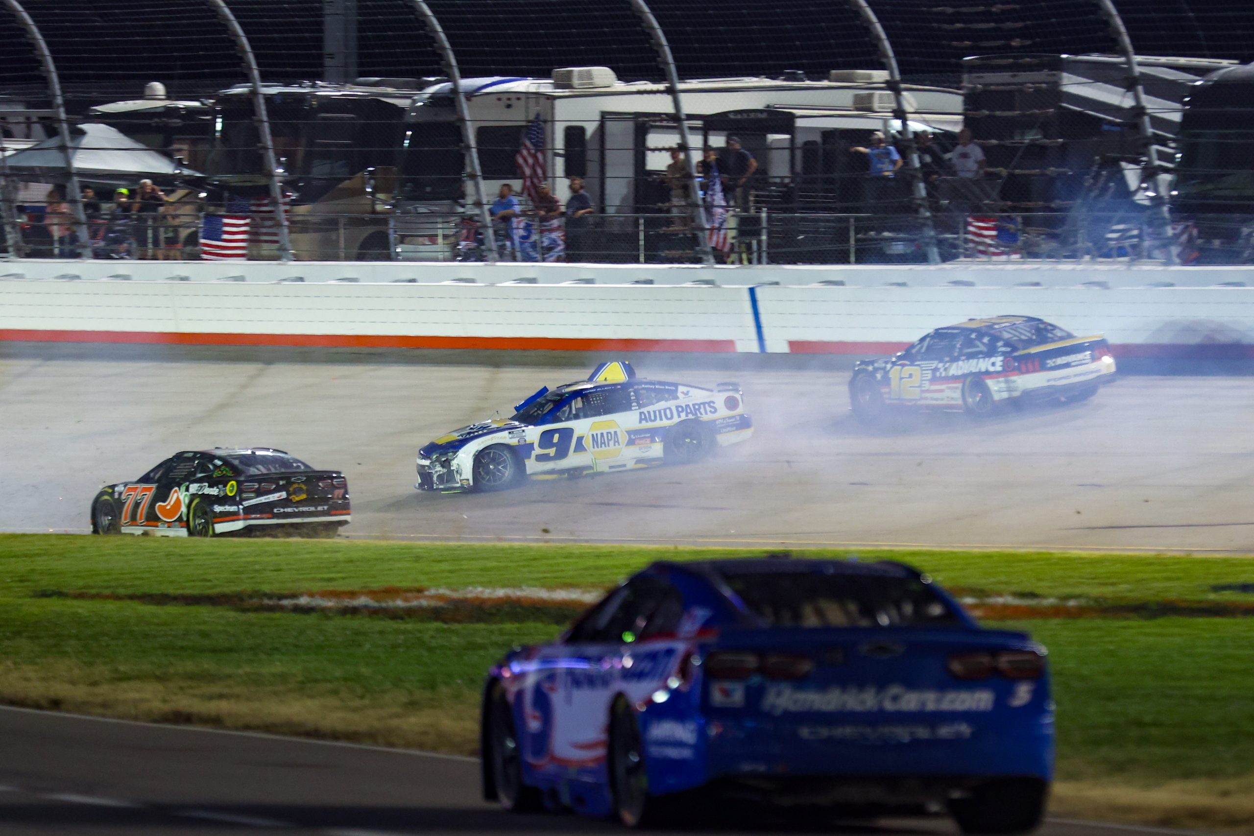Carson Hocevar (77) and Hendrick Motorsports driver Chase Elliott (9) and Team Penske driver Ryan Blaney (12) crash at the end of the Cracker Barrel 400 at Nashville Superspeedway. 