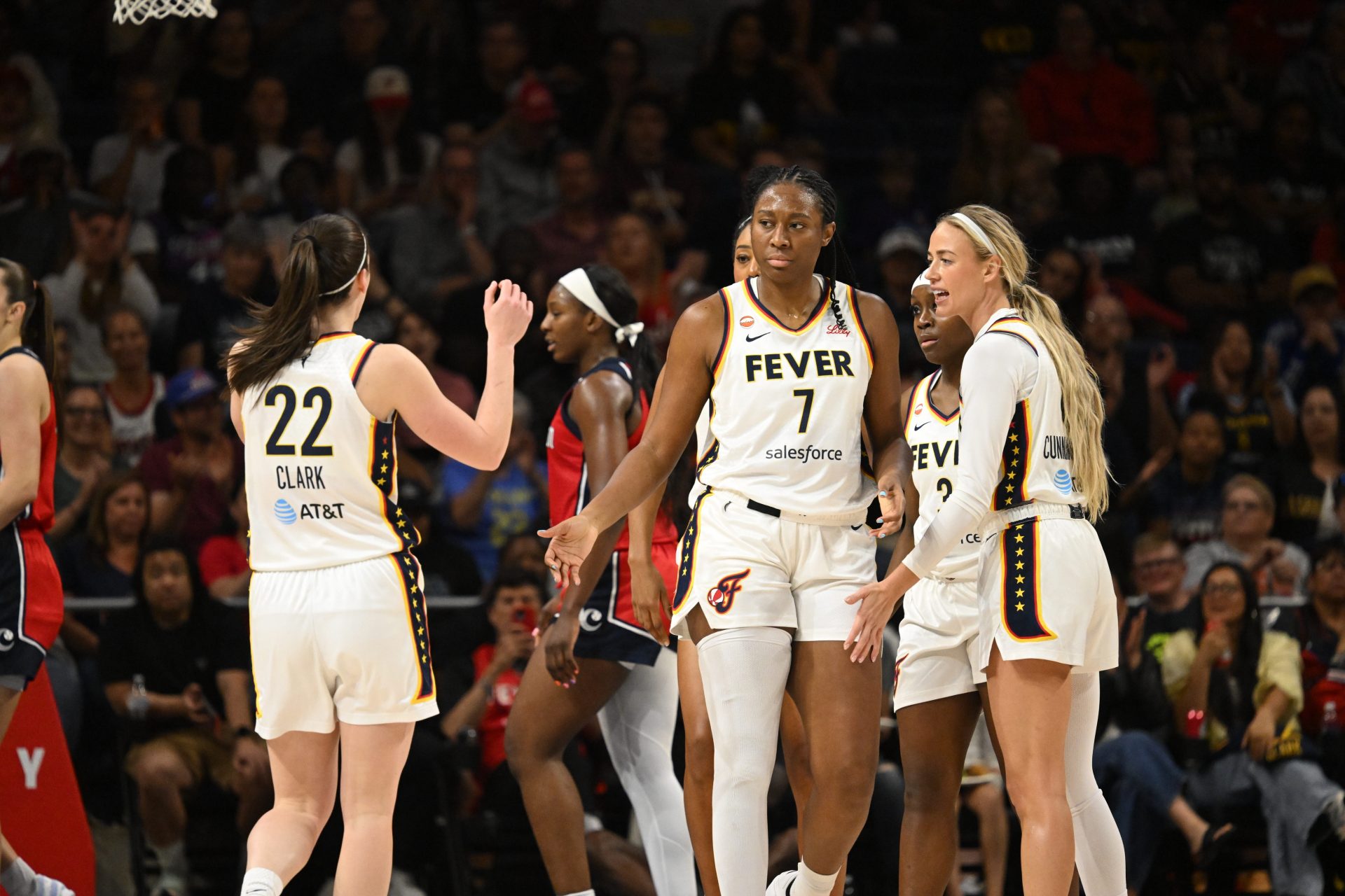 Indiana Fever center-forward Aliyah Boston (7) celebrates a play with guard Caitlin Clark (22) and guard Sophie Cunningham (8) against the Washington Mystics during the first quarter at CareFirst Arena - Source: Imagn Images