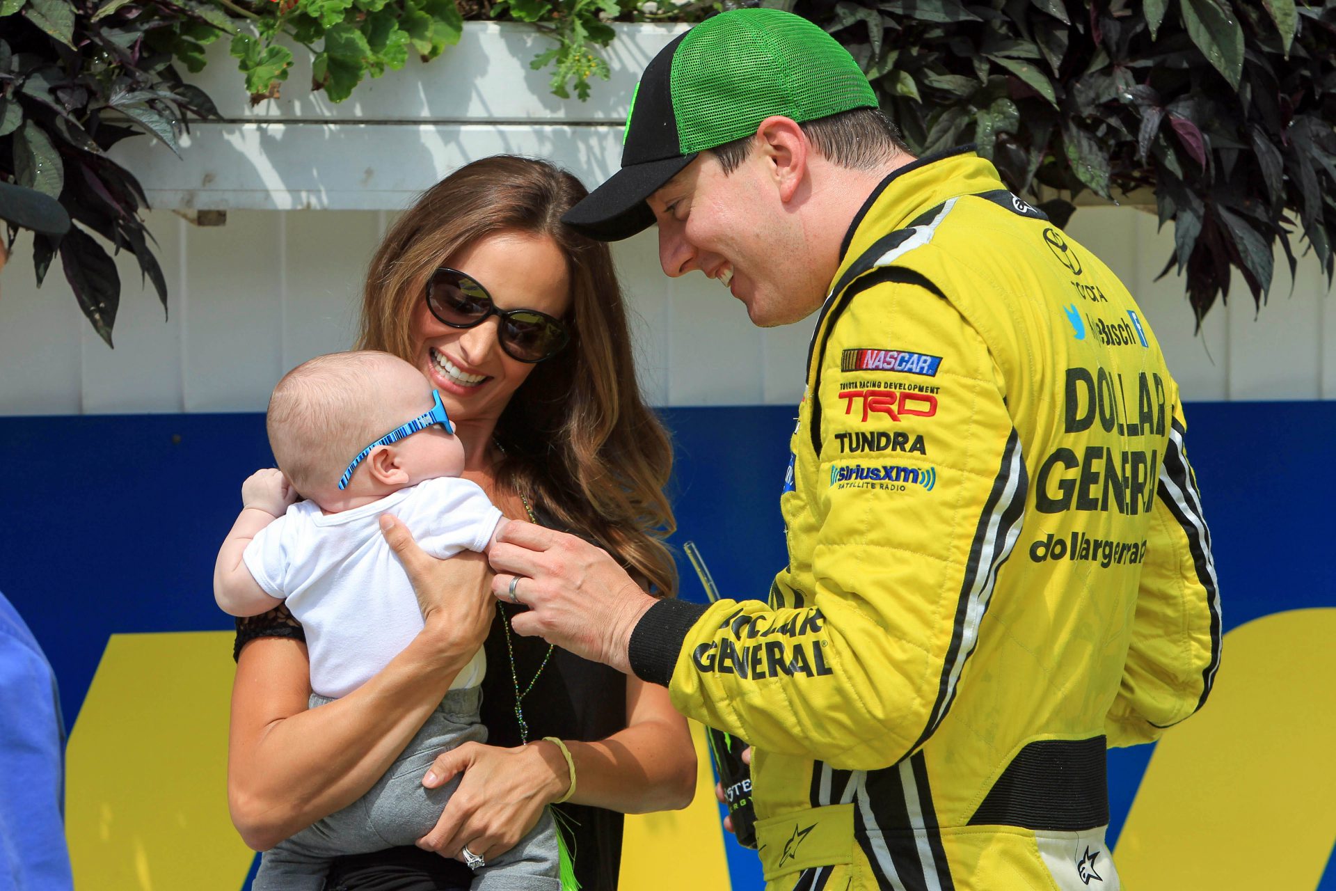 NASCAR Camping World Truck Series driver Kyle Busch (right) celebrates in victory lane with his wife Samantha Busch and their son Brexton Busch after winning the Pocono Mountains 150 at Pocono Raceway.