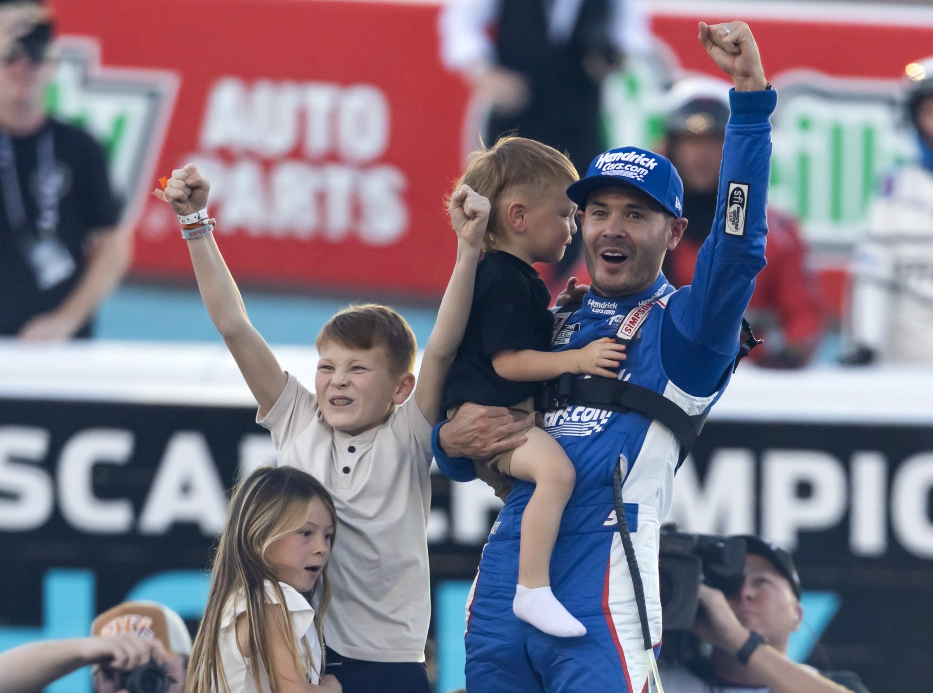 NASCAR Cup Series driver Kyle Larson (5) celebrates with children Owen Larson, Audrey Larson and Cooper Larson after clinching the 2025 NASCAR Cup Series Championship following the NASCAR Championship race at Phoenix Raceway.