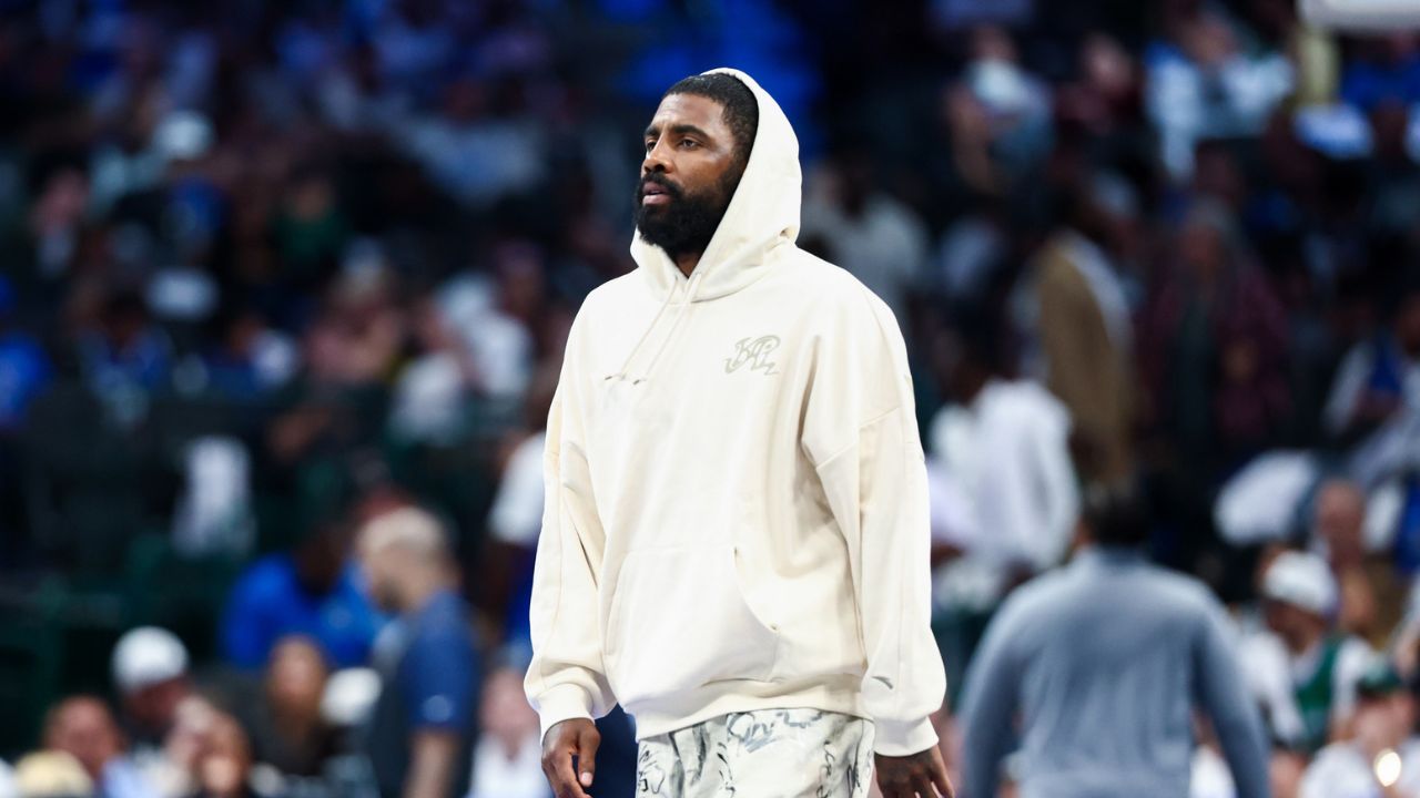 Dallas Mavericks injured guard Kyrie Irving walks across the court during the game against the San Antonio Spurs - Source: Imagn Images