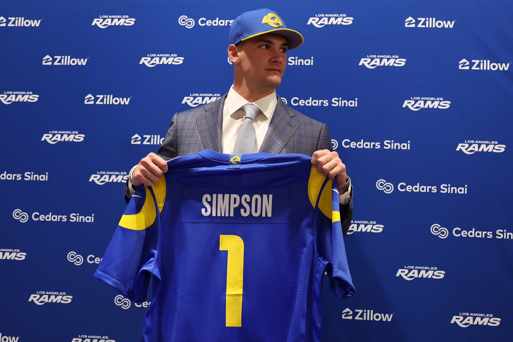 Los Angeles Rams first-round draft pick Ty Simpson poses with his jersey during a press conference at Code Next at Hollywood Park. Source: Imagn