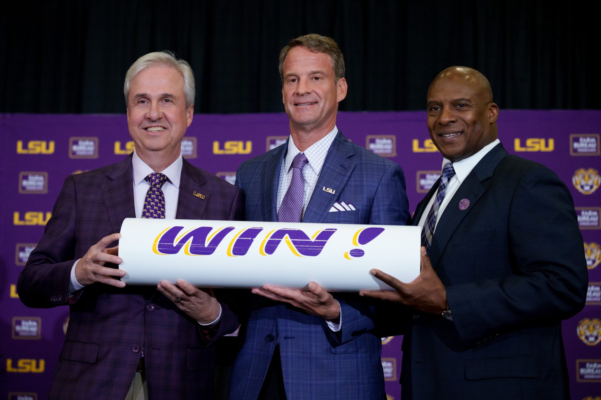 LSU president Wade Rousse, left, LSU new head coach Lane Kiffin and LSU athletic director Verge Ausberry stand together at South Stadium Club at Tiger Stadium.