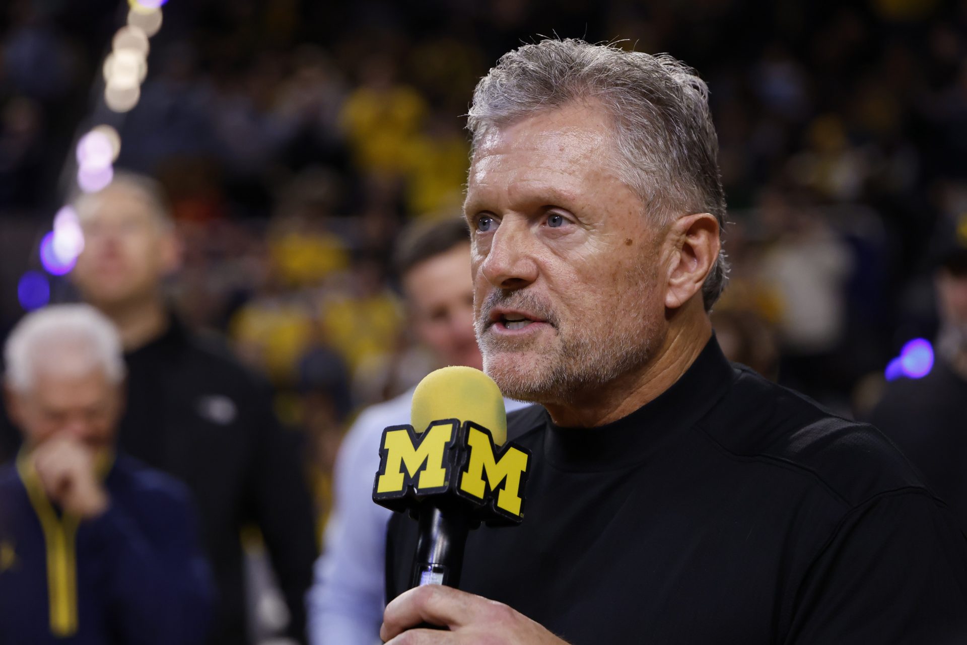 Michigan Wolverines football head coach Kyle Whittingham speaks to the crowd during a time out in the first half against the Southern California Trojans at Crisler Center.