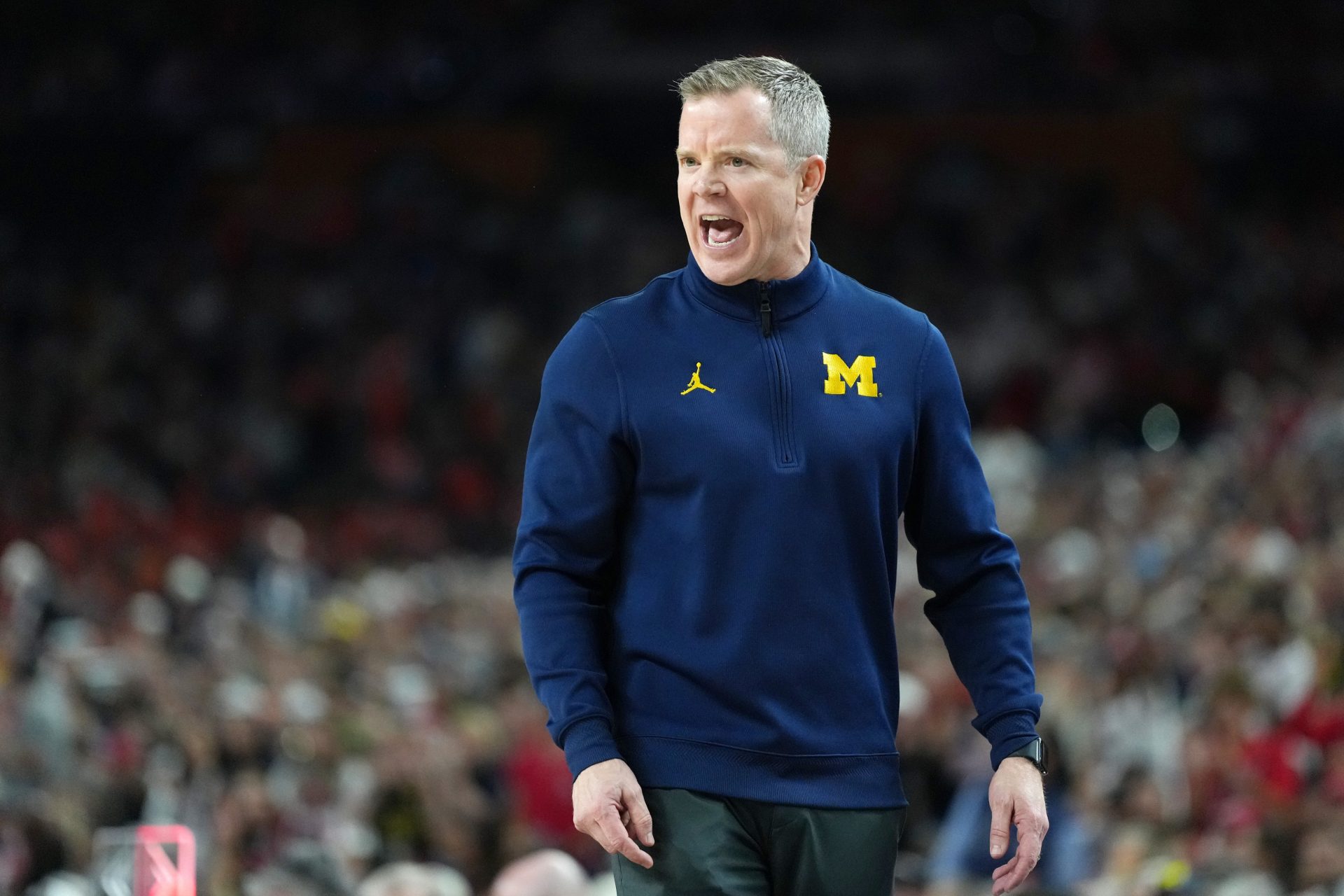 Michigan Wolverines head coach Dusty May reacts against the Arizona Wildcats during a semifinal of the Final Four of the men's 2026 NCAA Tournament at Lucas Oil Stadium.