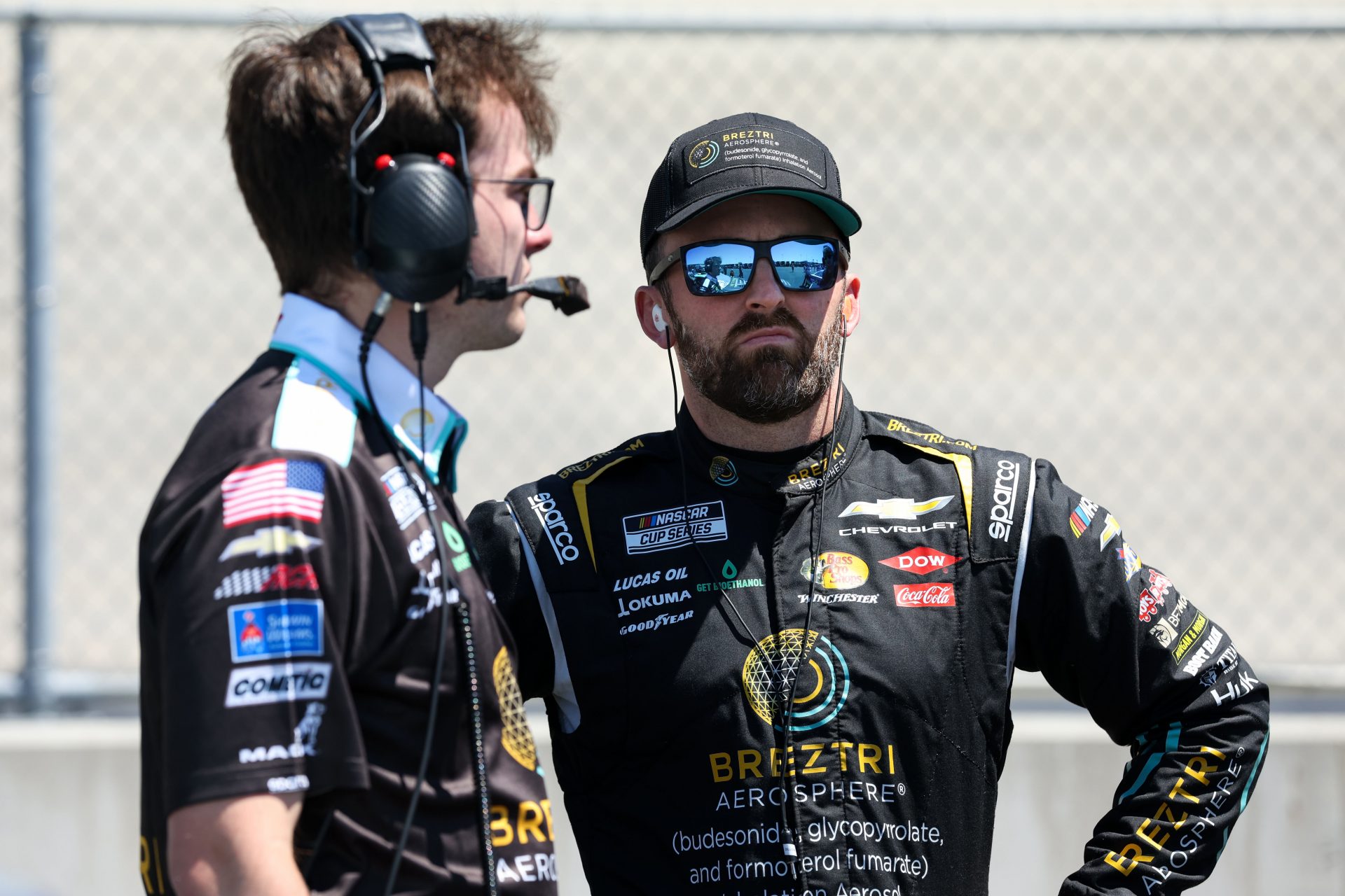 NASCAR Cup Series driver Austin Dillon (right) stands in the garage with a crew member during qualifying for the NASCAR All-Star Race at Dover Motor Speedway.