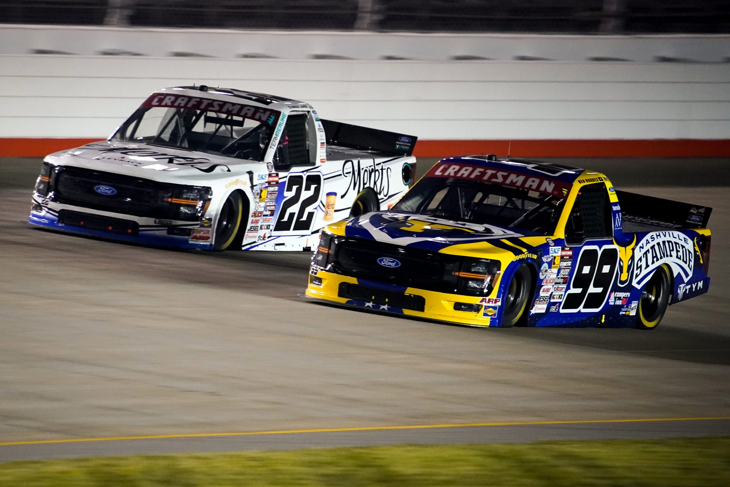 NASCAR Truck Series drivers Derek Lemke (22) and Ben Rhodes (99) race during the Allegiance 200 