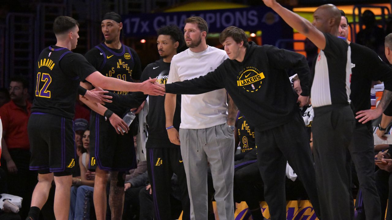Los Angeles Lakers guard Luka Doncic (77) and guard Austin Reaves (15) high five forward Jake LaRavia (12) in the first half of game two of the first round of the 2026 NBA Playoffs against the Houston Rockets at Crypto.com Arena - Source: Imagn Images