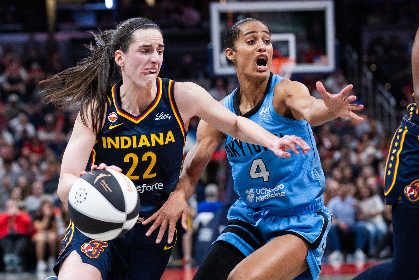 Indiana Fever guard Caitlin Clark (22) dribbles the ball while  Chicago Sky guard Skylar Diggins (4) defends in the second half at Gainbridge Fieldhouse - Source: Imagn Images