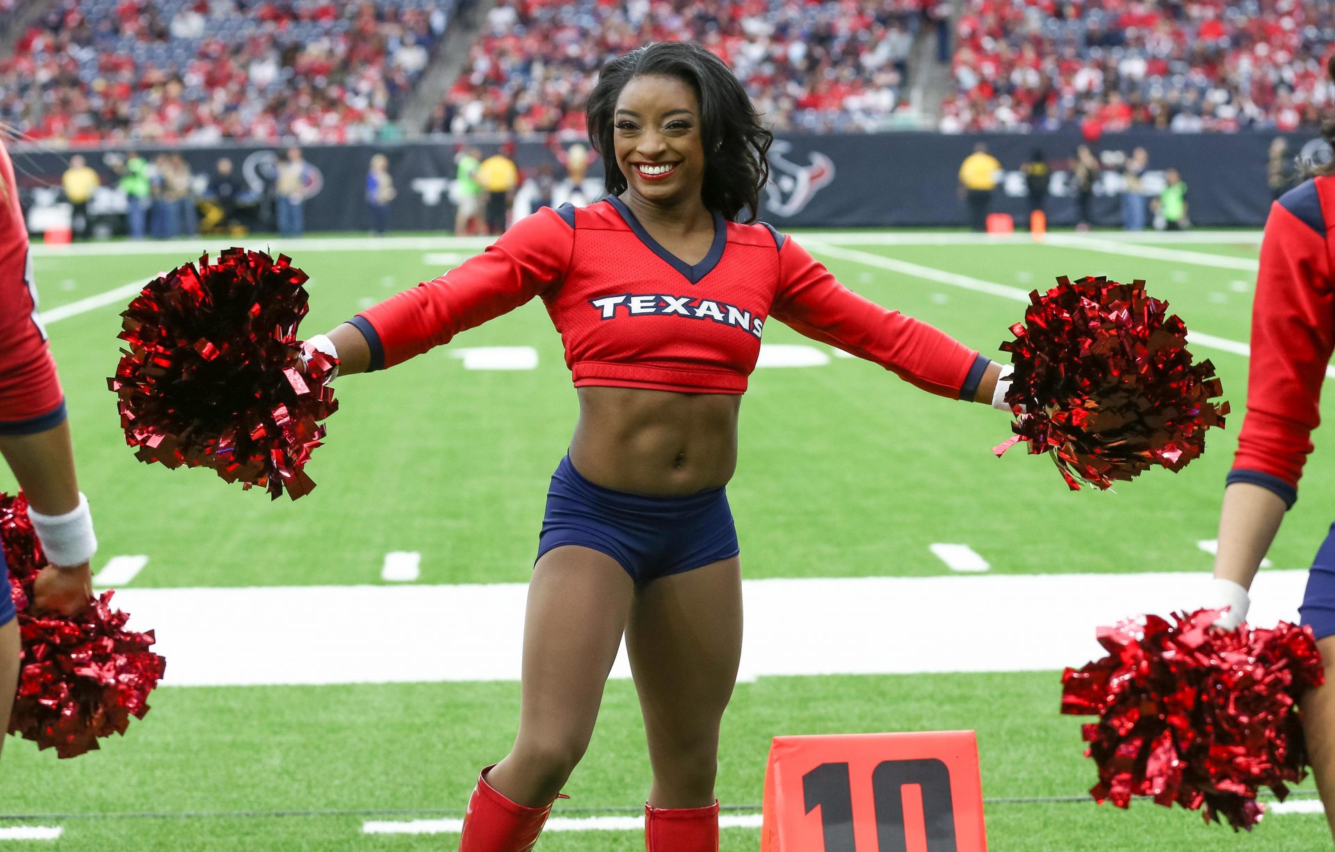 Olympic athlete Simone Biles performs as an honorary Houston Texans cheerleader during the game against the San Francisco 49ers at NRG Stadium.
