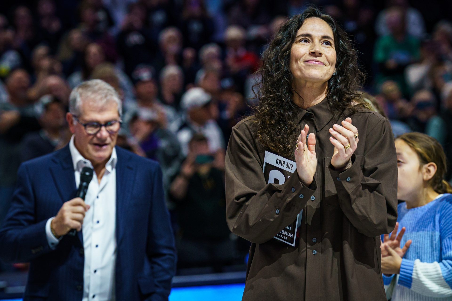 Former UConn Huskies player Sue Bird is honored with the retirement of her kersey number along with UConn Huskies head coach Geno Auriemma before the start of the game against the  watches from the sideline as they take on the UConn Huskies
Source: Imagn