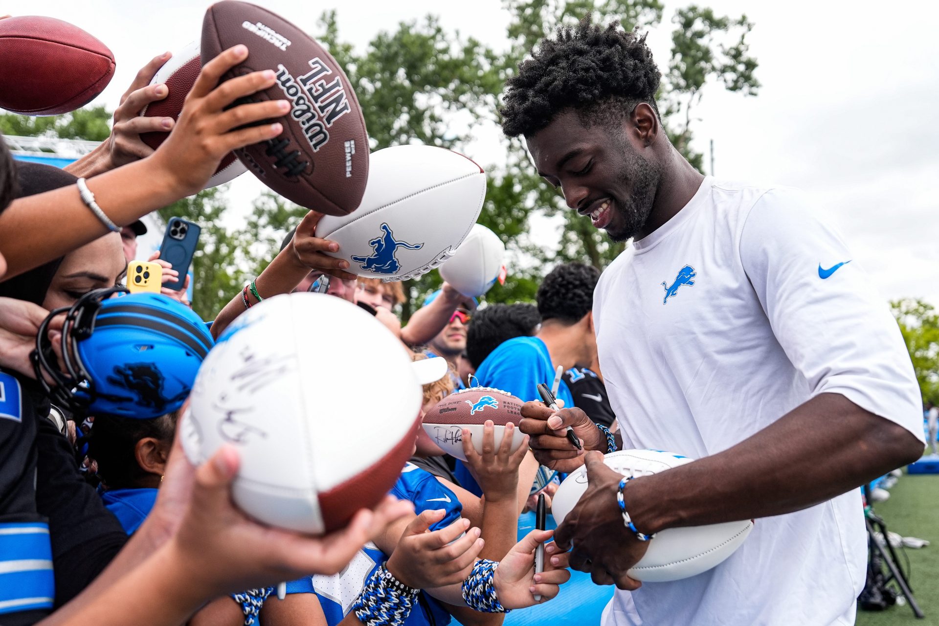 Detroit Lions cornerback Terrion Arnold (6) signs autographs for fans after practice at training camp at Meijer Performance Center in Allen Park on Thursday, Aug. 21, 2025.
