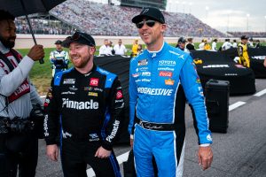 NASCAR Cup Series driver Tyler Reddick, left, and Denny Hamlin, right, walk to their cars as rain falls before the Cracker Barrel 400 at Nashville Superspeedway in Lebanon, Tenn., Sunday, May 31, 2026.