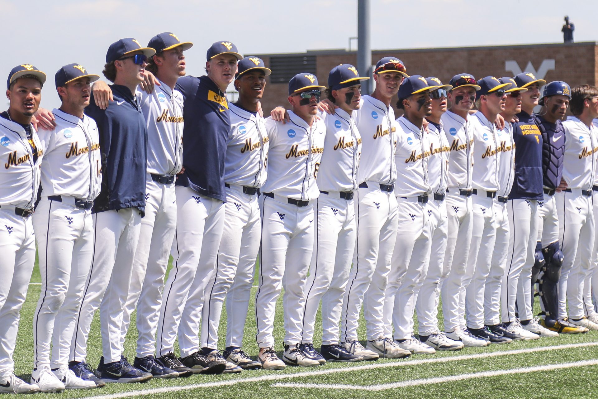 West Virginia Mountaineers players sing “Country Roads” after defeating the Cal Poly Mustangs at Kendrick Family Ballpark.
