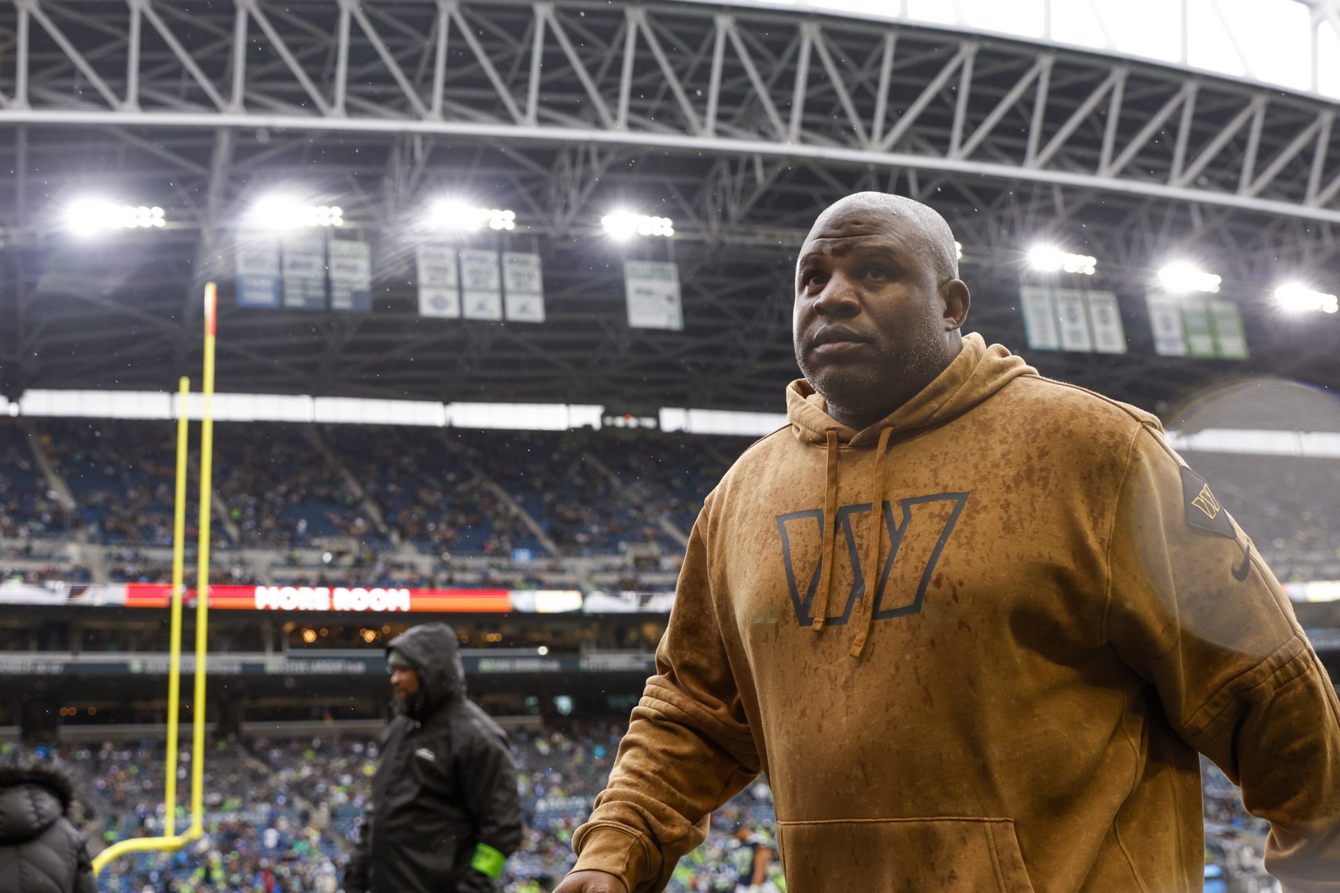Washington Commanders offensive coordinator Eric Bieniemy returns to the locker room following pregame warmups against the Seattle Seahawks at Lumen Field.